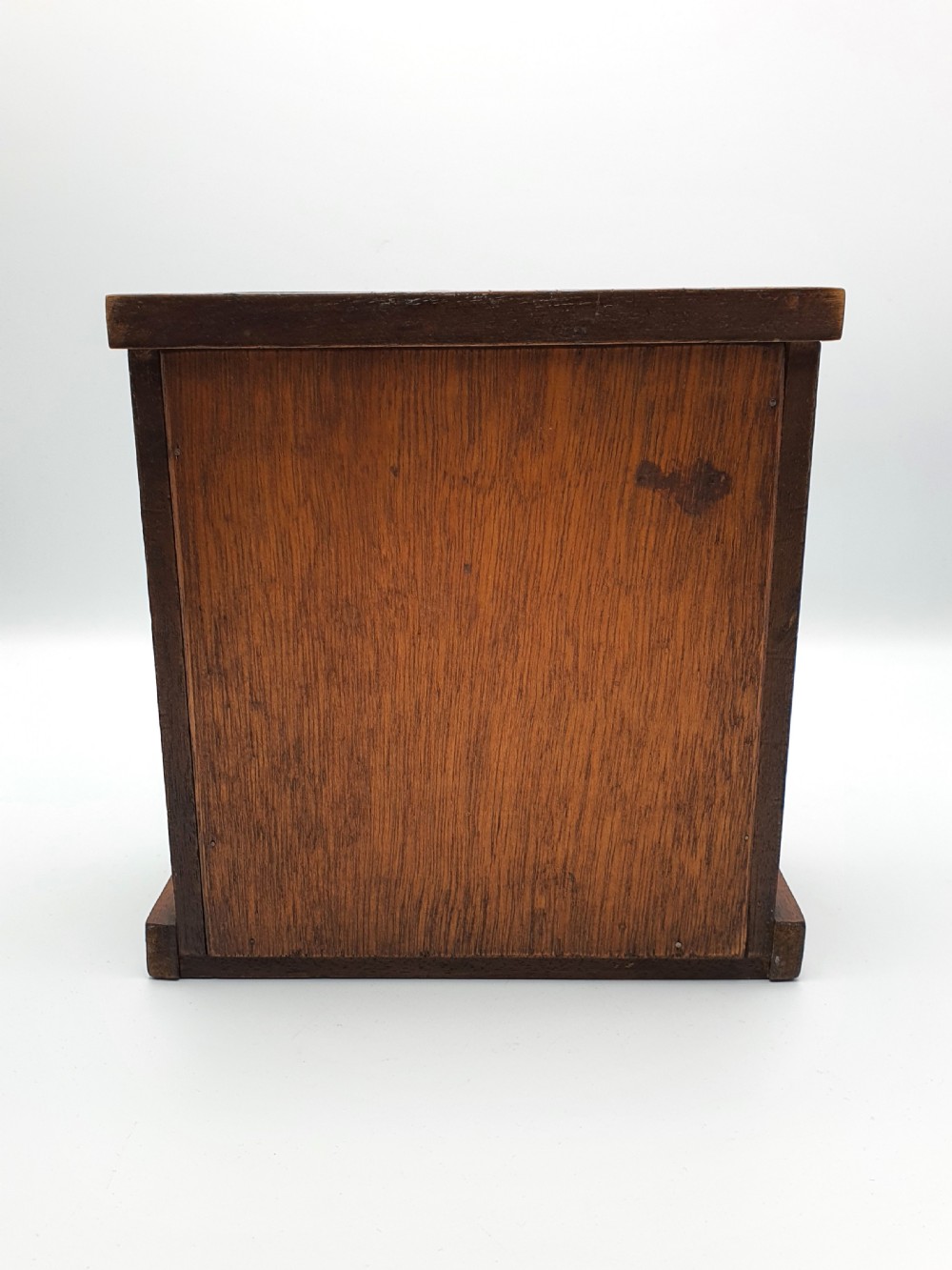 A small mahogany three-drawer miniature chest with brass drop handles and inlaid wood banding. View VI
