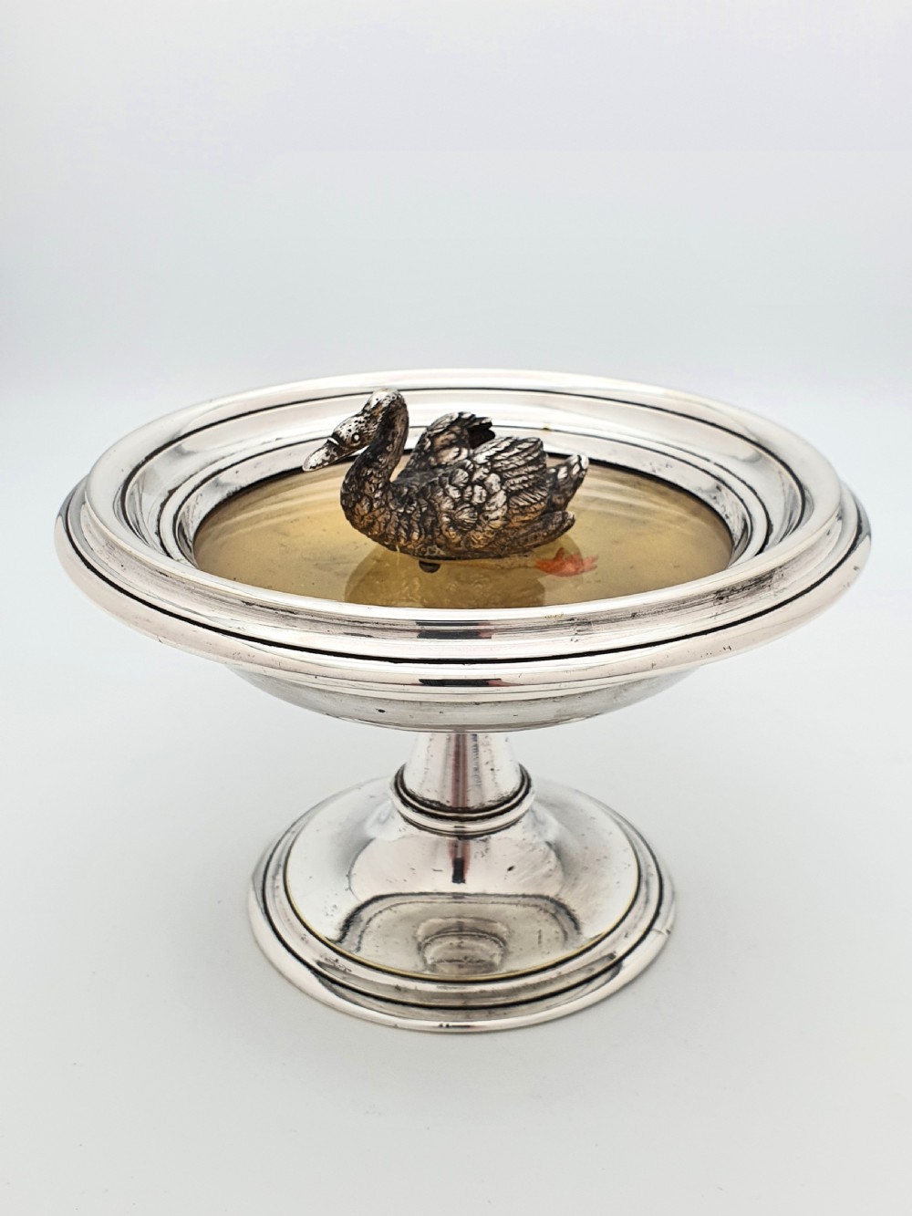A circular silver pedestal comport featuring a central cast silver swan figure mounted inside a shallow basin. View II