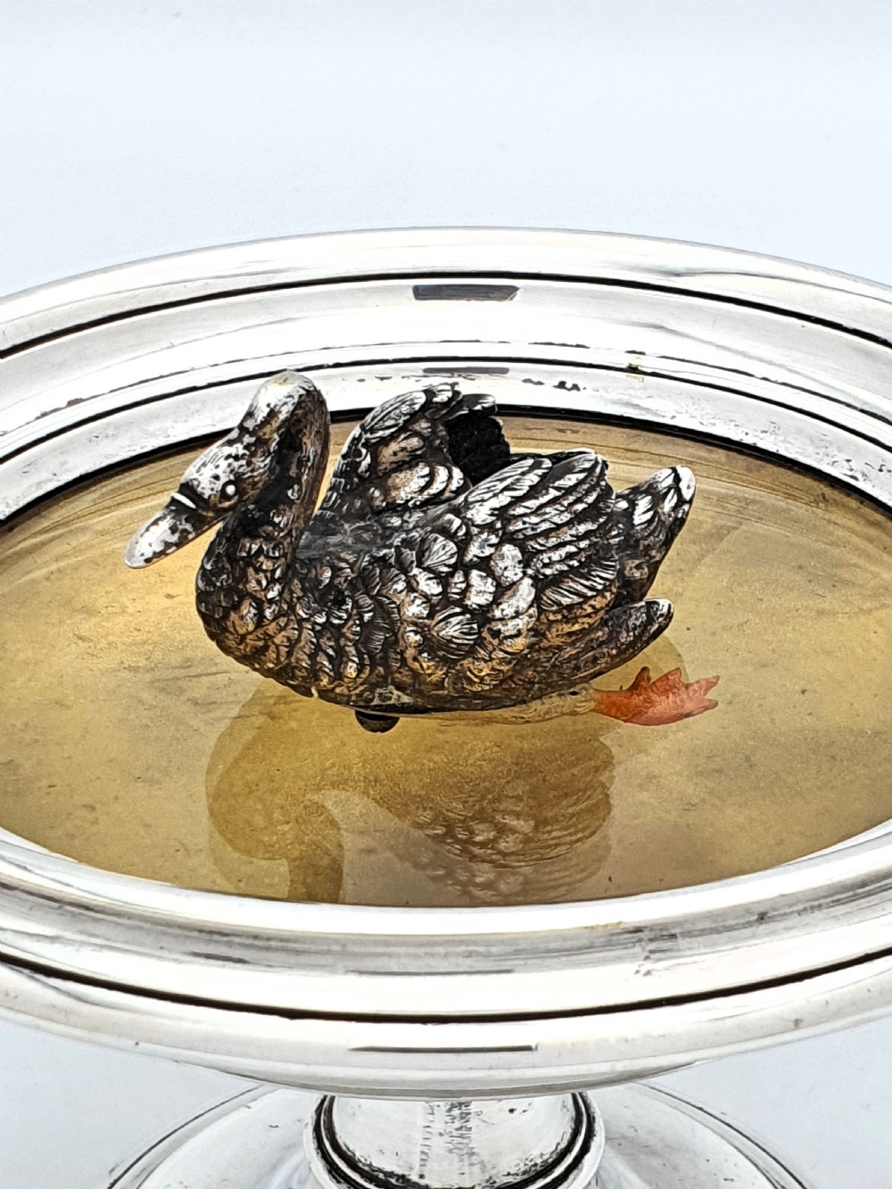 A circular silver pedestal comport featuring a central cast silver swan figure mounted inside a shallow basin. View III