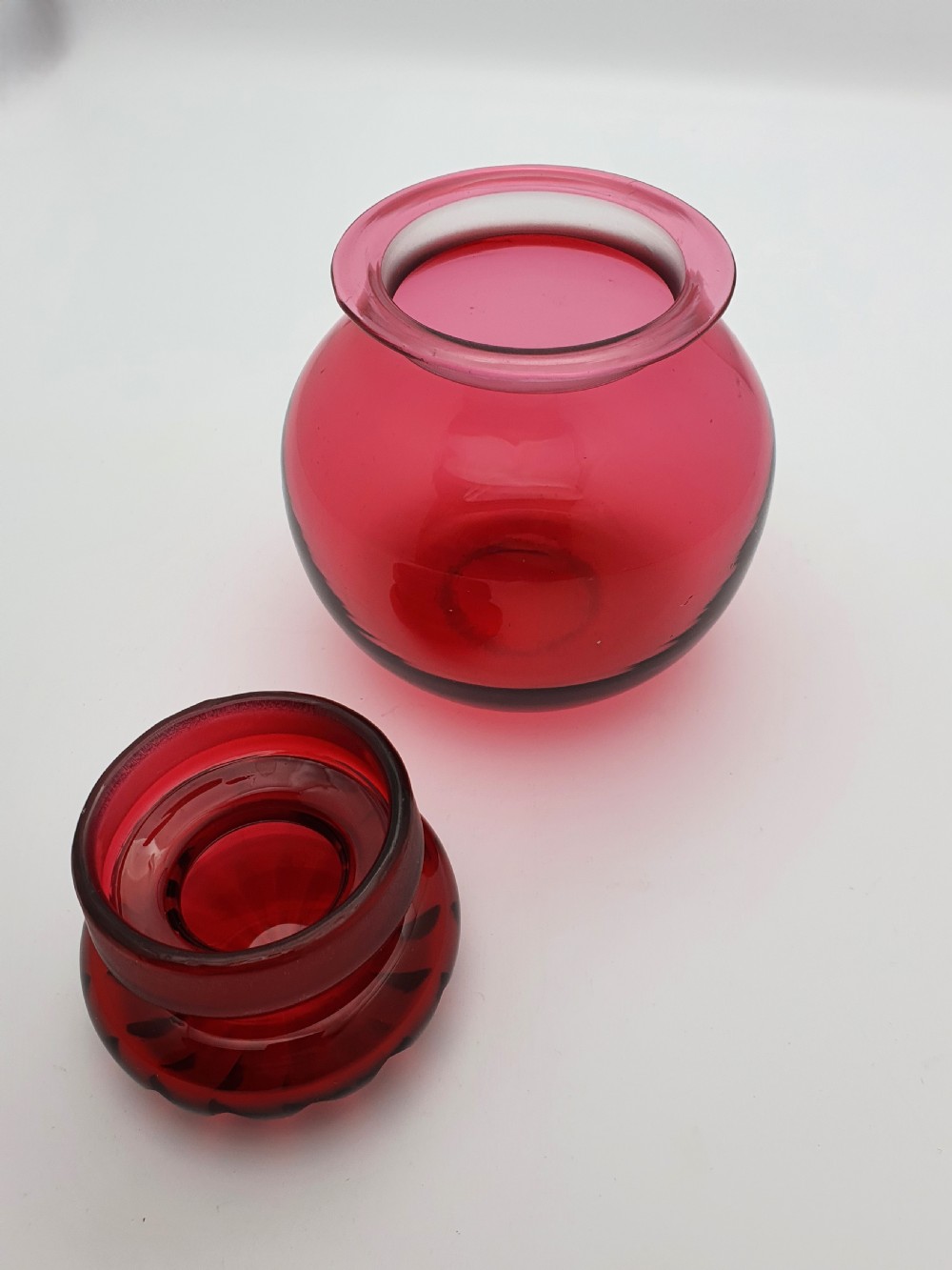 A spherical Edwardian cranberry red glass jar with a flanged neck and a faceted cut-glass stopper. View III