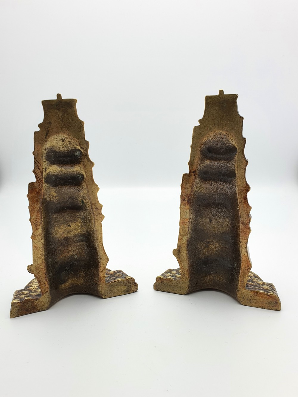 A pair of solid brass bookends featuring a relief design of a tall sailing ship on ocean waves. View V