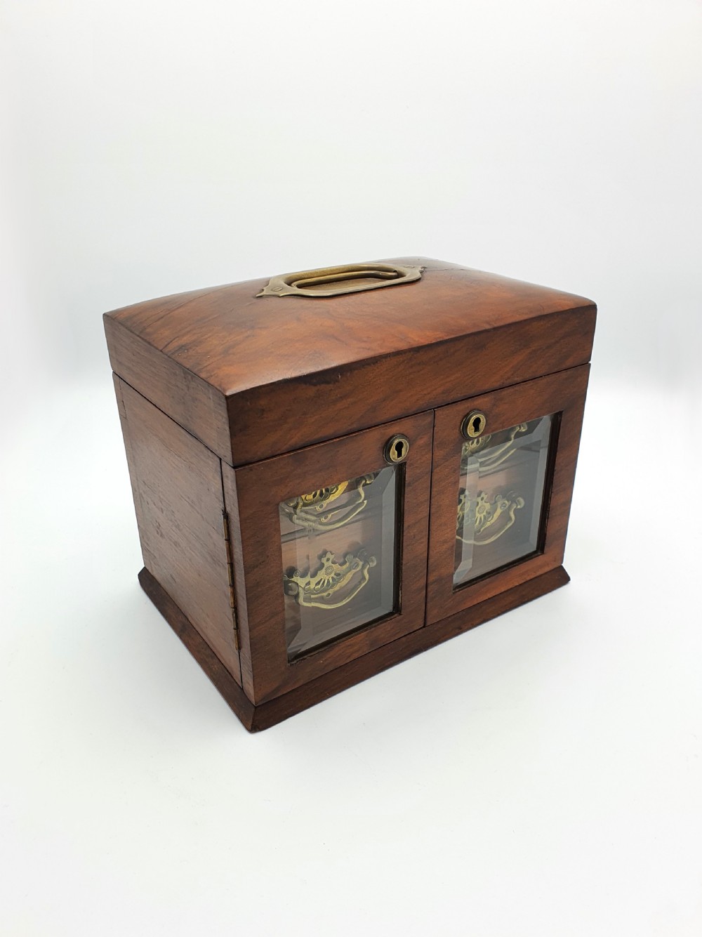 A Victorian walnut jewellery chest with open glass-panelled side doors, two pull-out drawers with brass handles, and an open lid revealing a button-tufted green velvet interior. View III