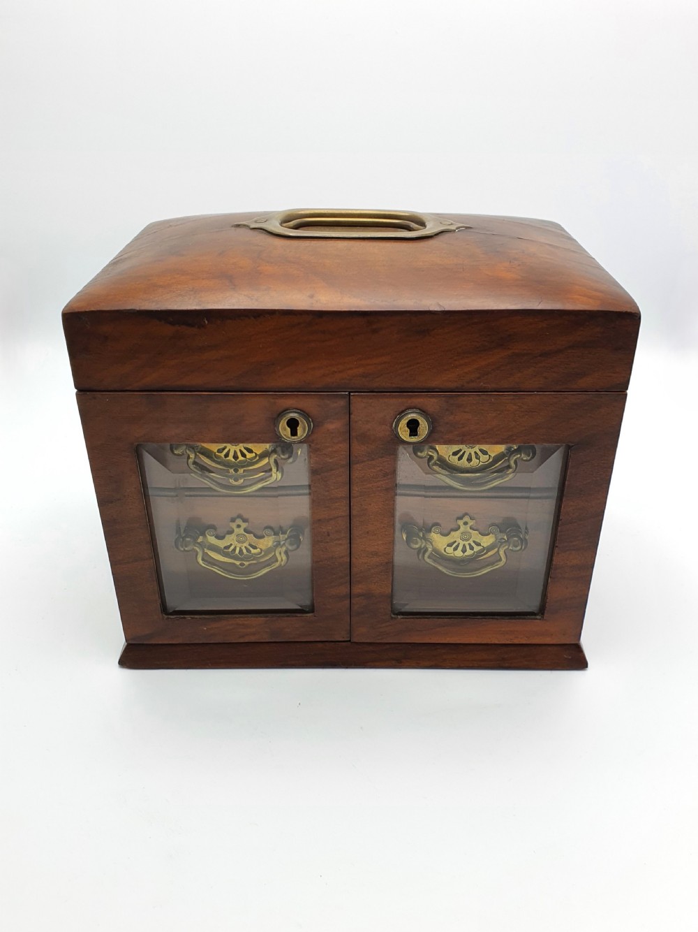 A Victorian walnut jewellery chest with open glass-panelled side doors, two pull-out drawers with brass handles, and an open lid revealing a button-tufted green velvet interior. View VII