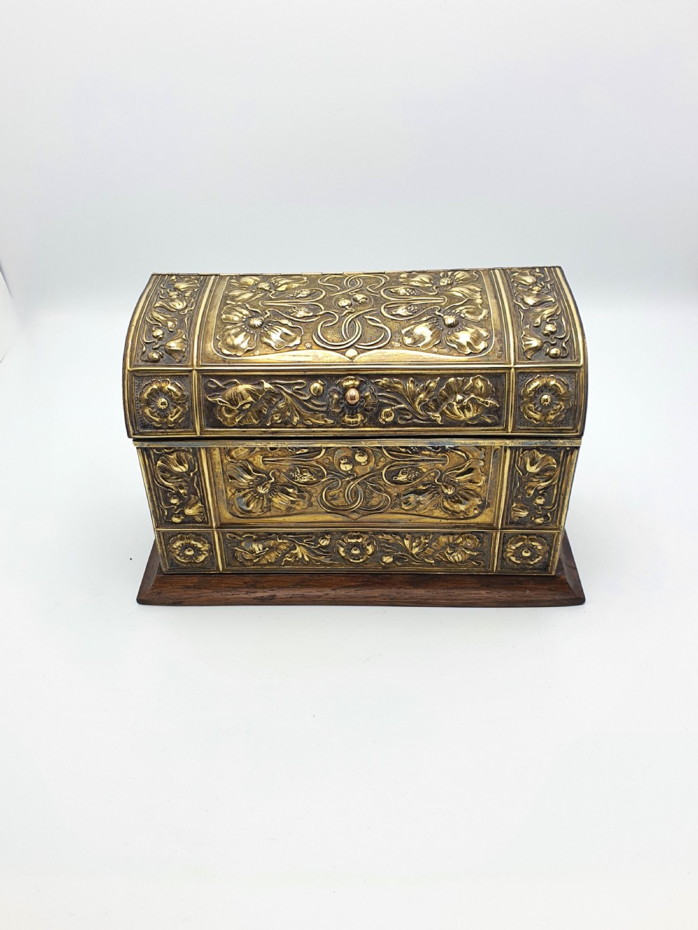 An Edwardian Art Nouveau document box featuring embossed floral brass panels over a dark timber base with a domed lid. View II