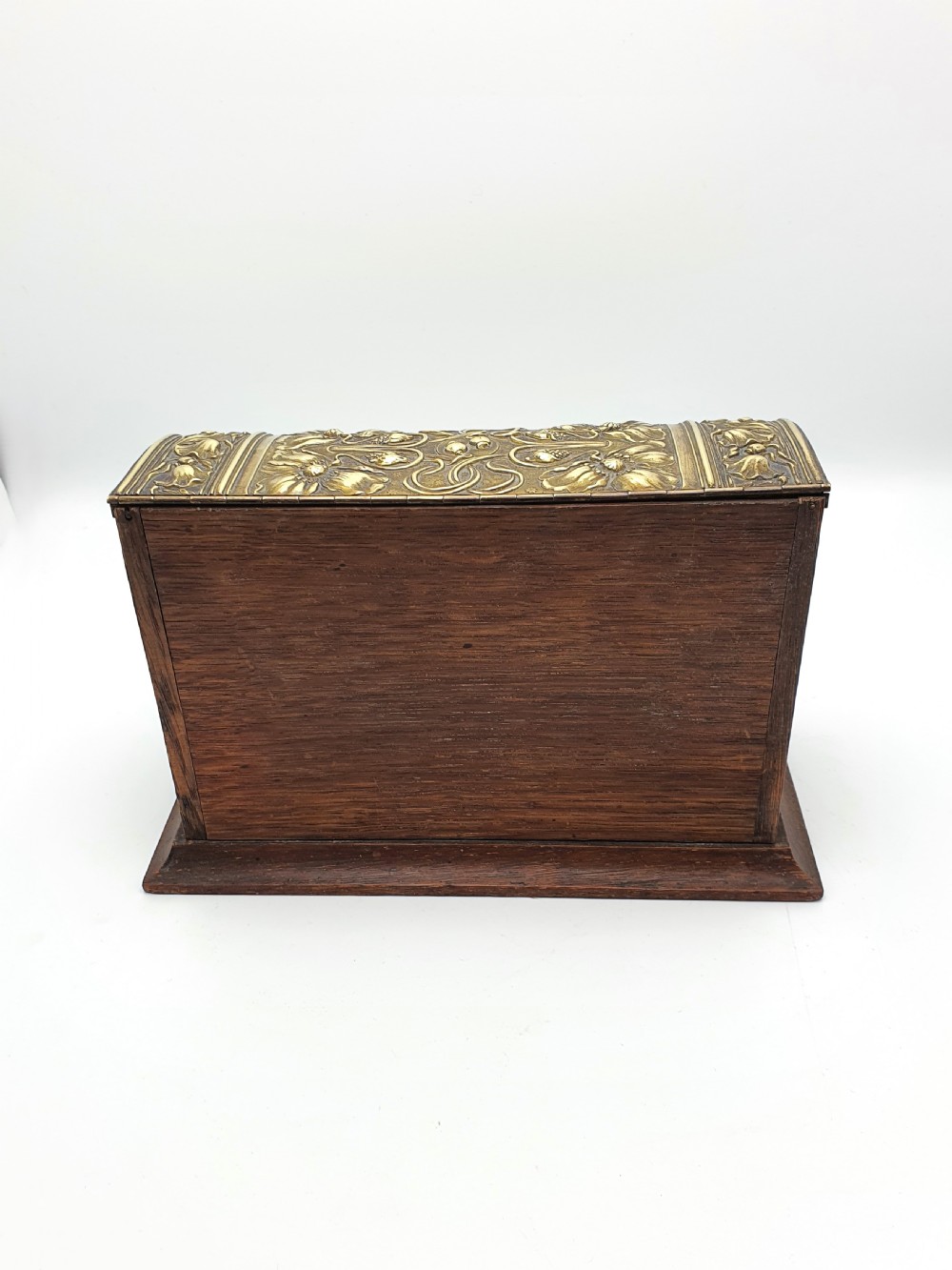 An Edwardian Art Nouveau document box featuring embossed floral brass panels over a dark timber base with a domed lid. View VI