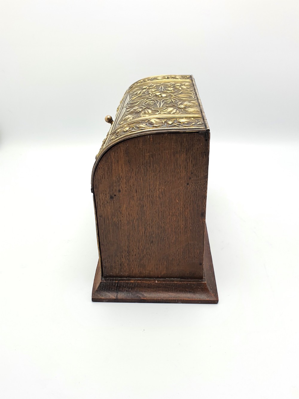 An Edwardian Art Nouveau document box featuring embossed floral brass panels over a dark timber base with a domed lid. View VII