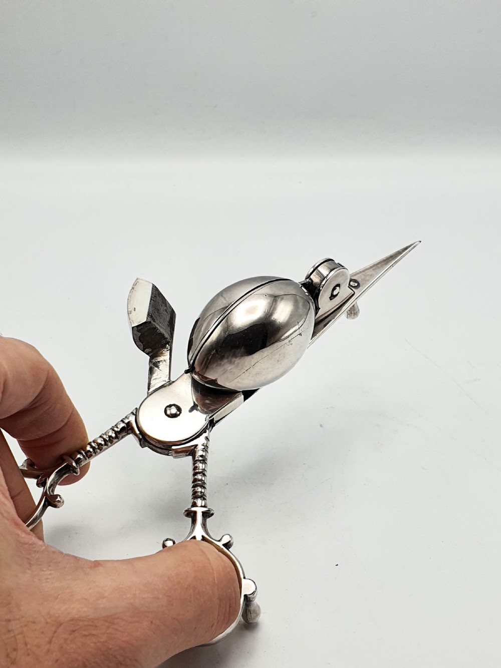A Victorian silver-plated candle snuffer with scissor trimmers resting on an elongated tray with gadrooned borders. View V