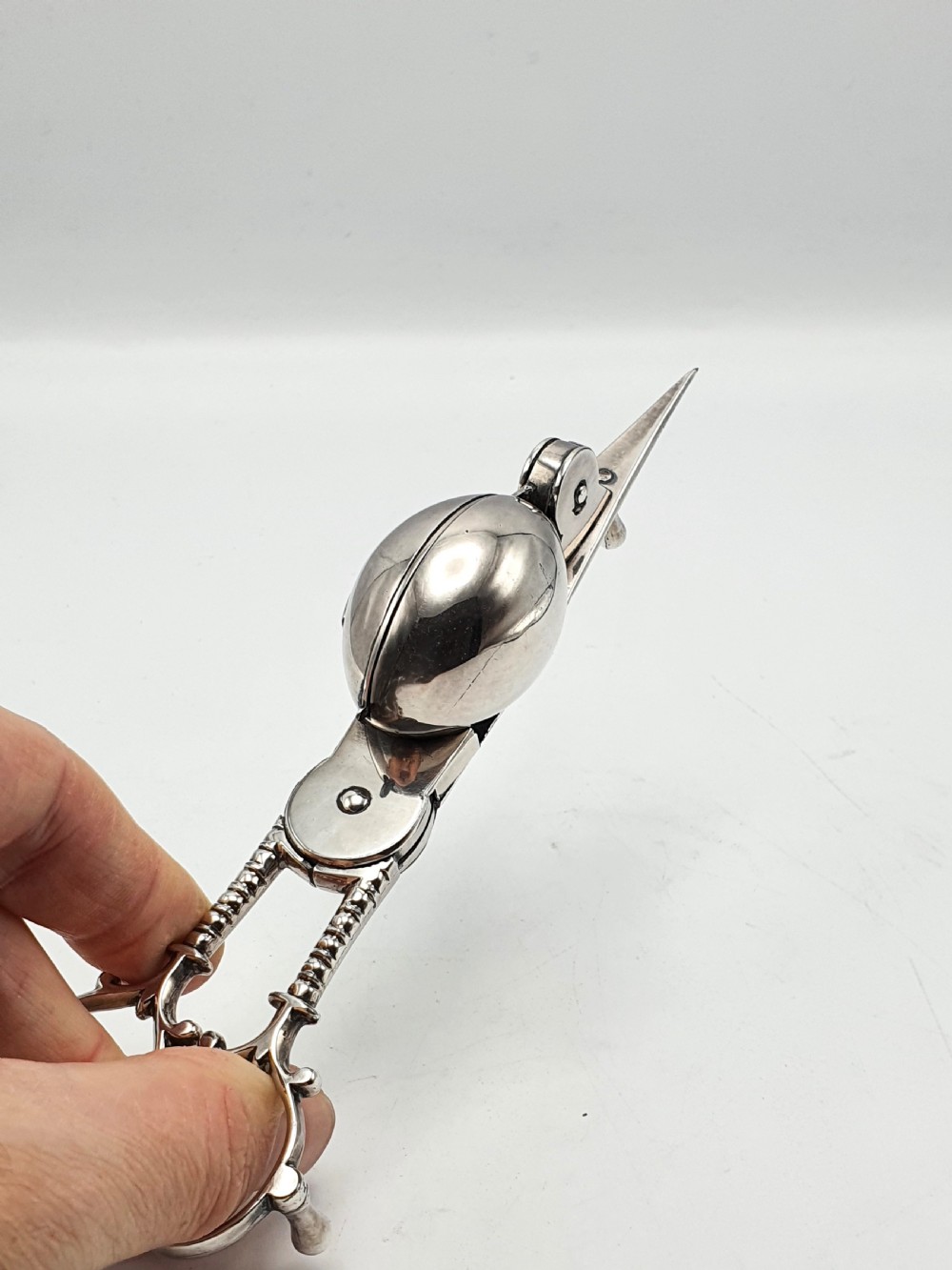 A Victorian silver-plated candle snuffer with scissor trimmers resting on an elongated tray with gadrooned borders. View VII