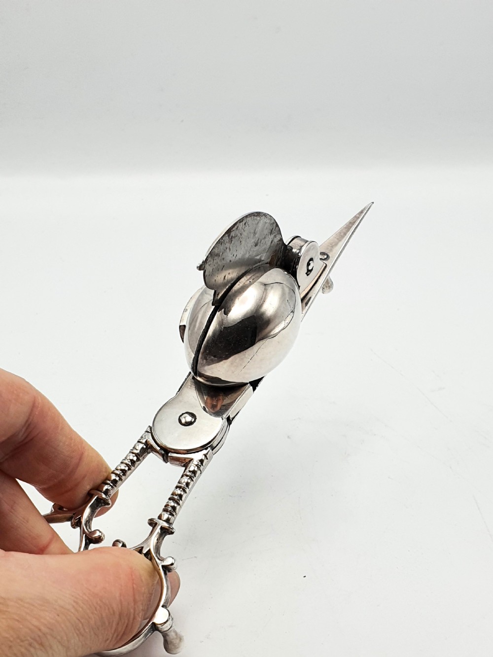 A Victorian silver-plated candle snuffer with scissor trimmers resting on an elongated tray with gadrooned borders. View VIII