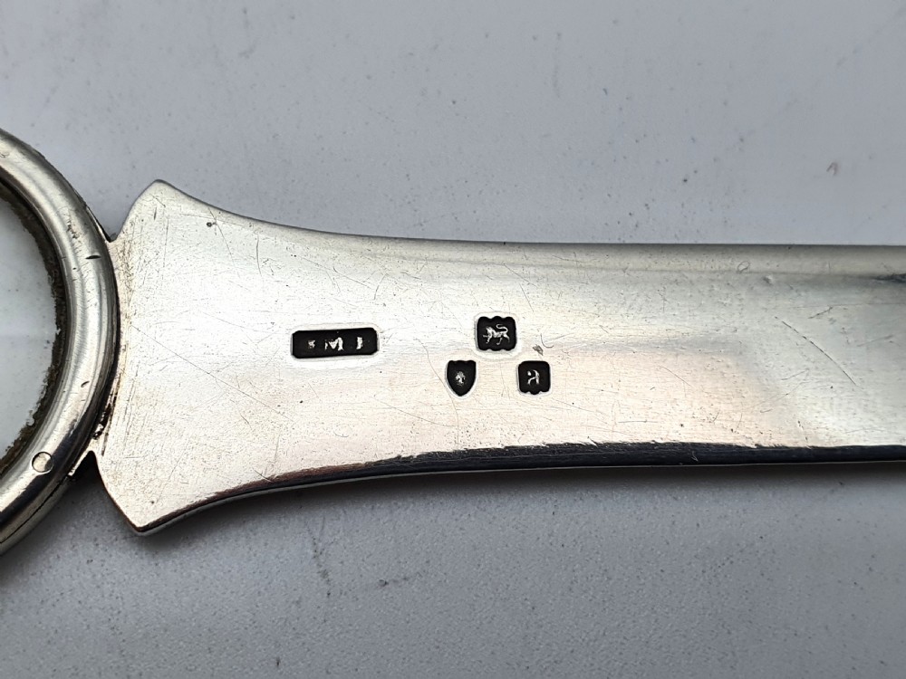 A solid silver Victorian letter opener featuring an engraved ruler edge, makers inscription, and a crown-topped circular finial. View III