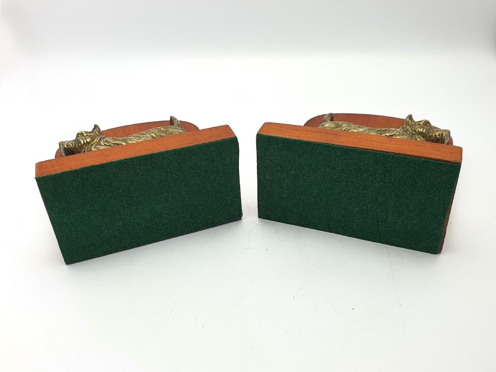 A pair of vintage 1930s wooden bookends featuring detailed cast brass reliefs of Scottish Terriers mounted on the front. View IV