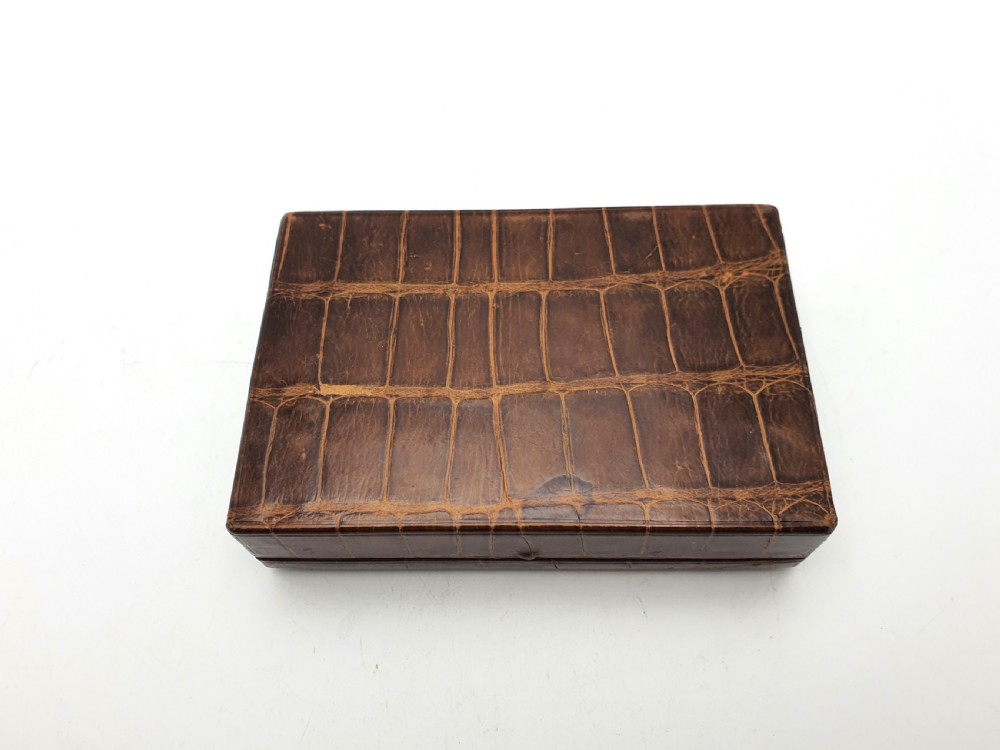 A rectangular 1920s jewellery box covered in polished chestnut brown crocodile skin with distinct natural scale patterning. View V