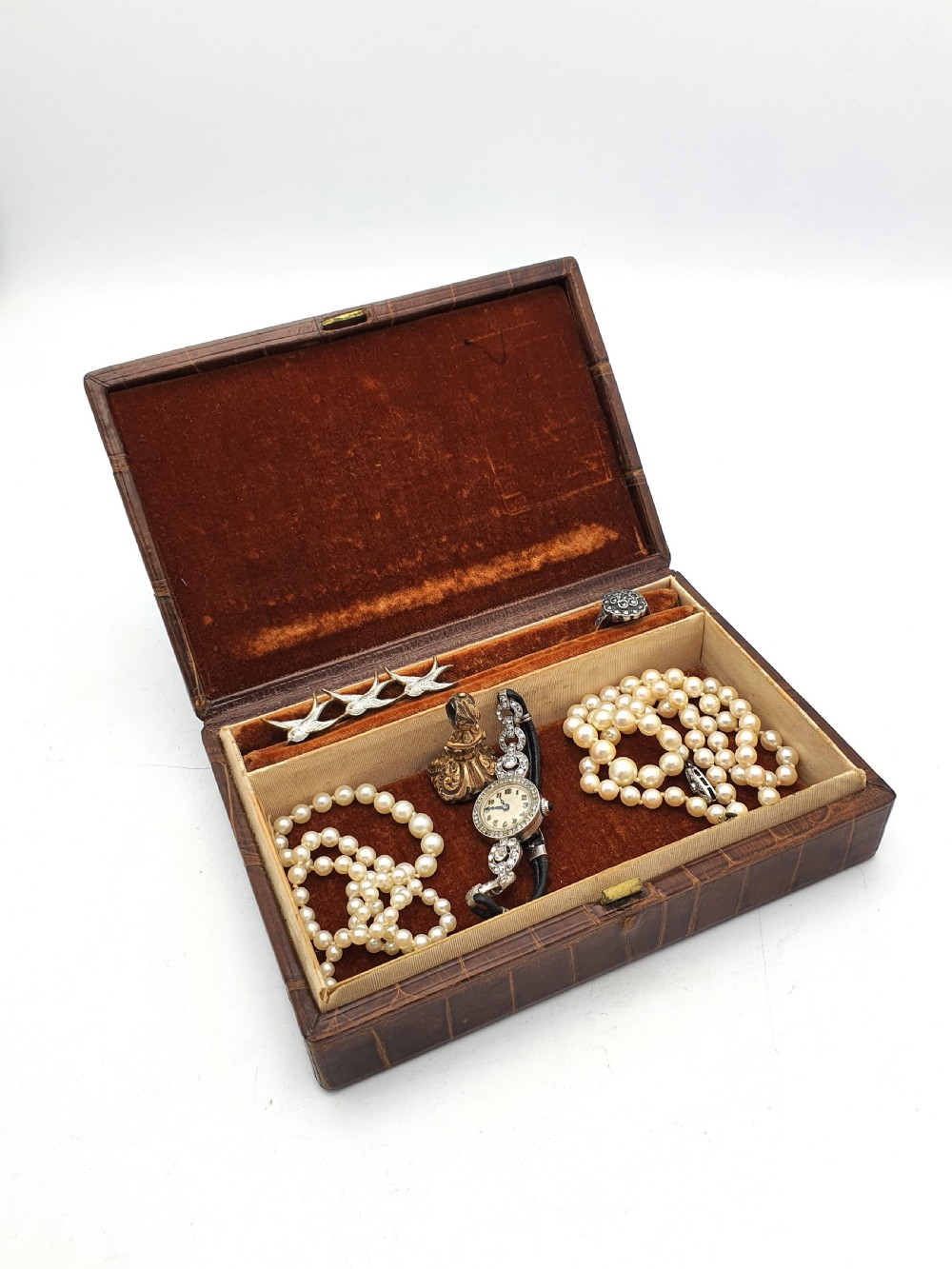 A rectangular 1920s jewellery box covered in polished chestnut brown crocodile skin with distinct natural scale patterning. View VI