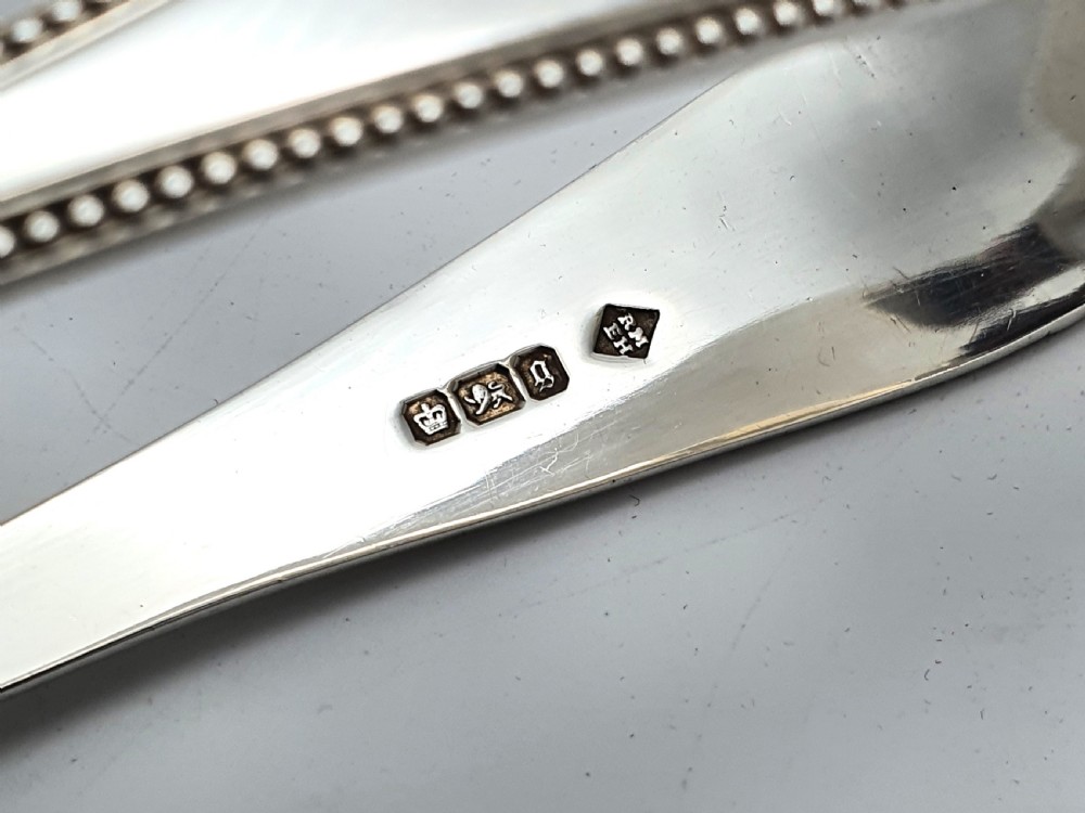 Late Victorian sterling silver serving tongs with intricately pierced scrollwork blades and beaded edge details. View V