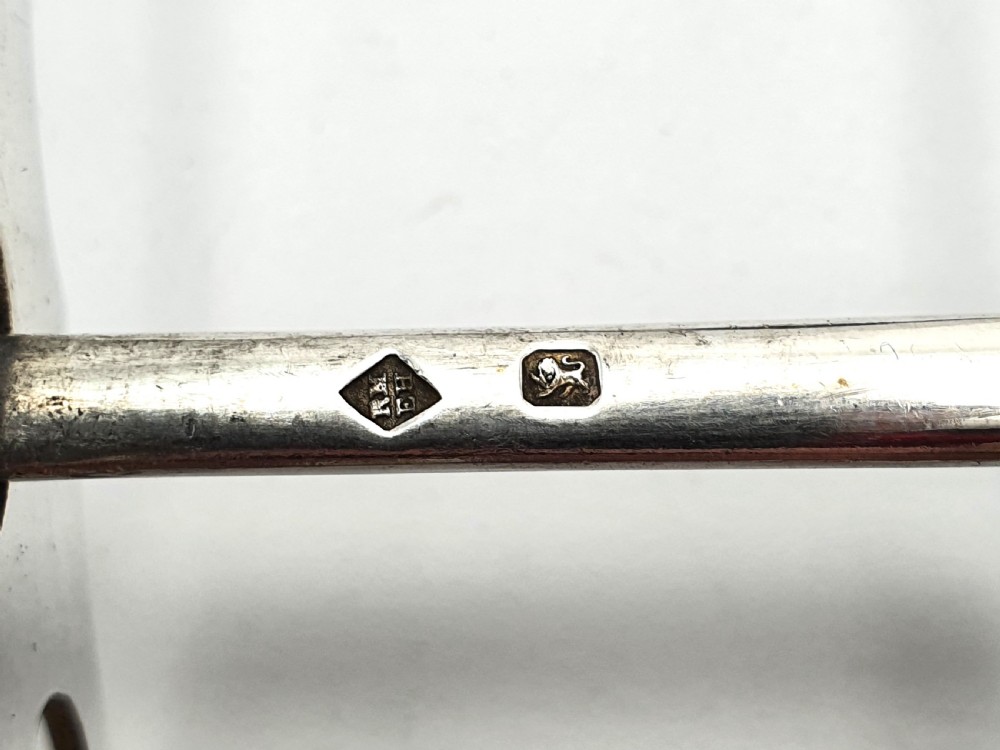 Late Victorian sterling silver serving tongs with intricately pierced scrollwork blades and beaded edge details. View VI