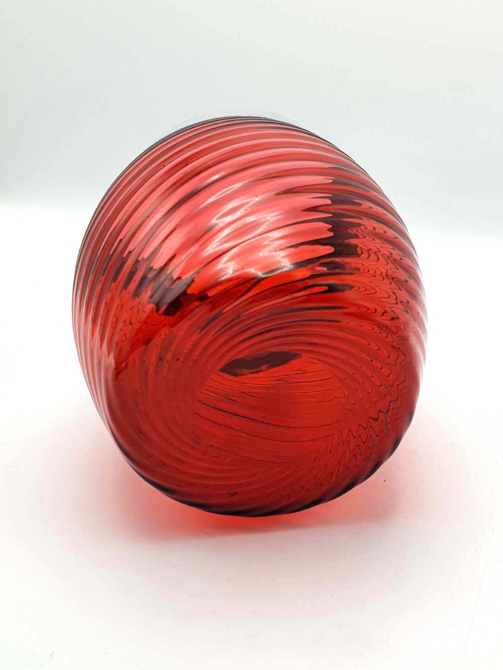A Victorian ribbed cranberry red glass biscuit barrel featuring a silver-plated rim, handle mounts, and a lid surmounted by a stag head finial. View VI