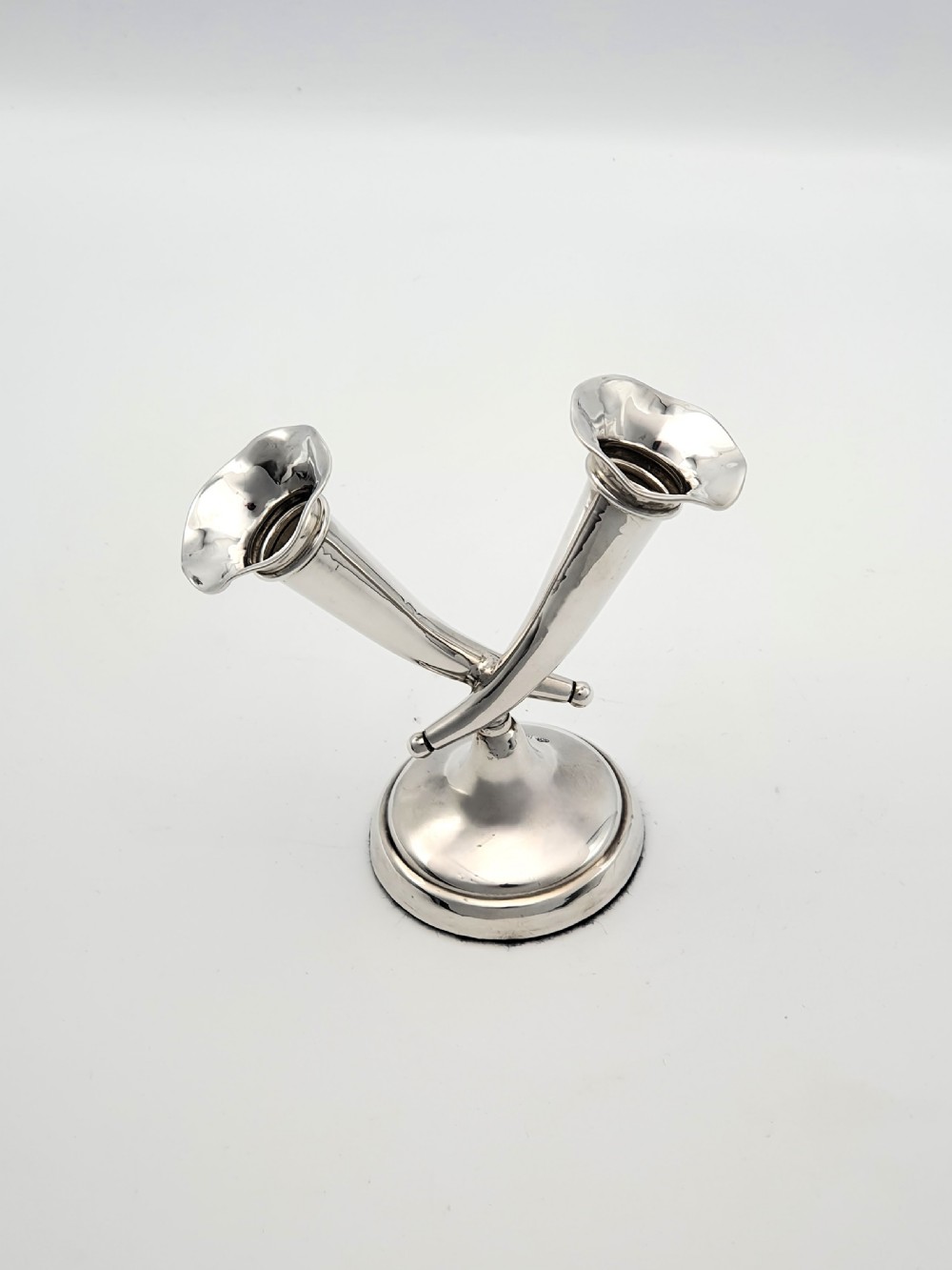An Edwardian sterling silver twin epergne featuring two crossed trumpet-shaped fluted vases set upon a circular weighted base. View II