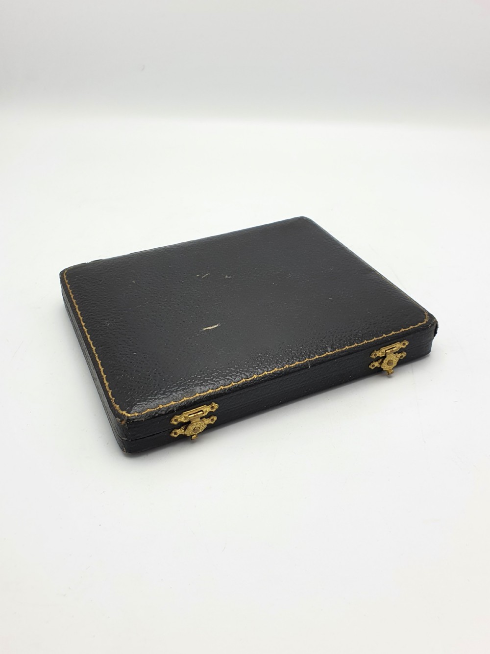 A set of six silver Art Deco teaspoons featuring geometric enamel terminals in a black velvet and satin fitted presentation case. View IV
