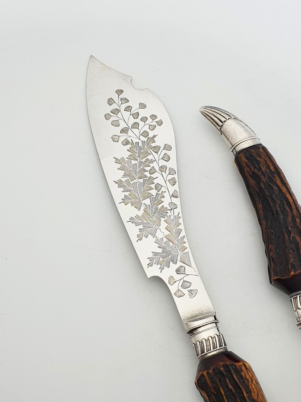 A pair of Victorian silver-plated fish servers with natural antler handles and engraved leaf patterns on the blade and fork. View III