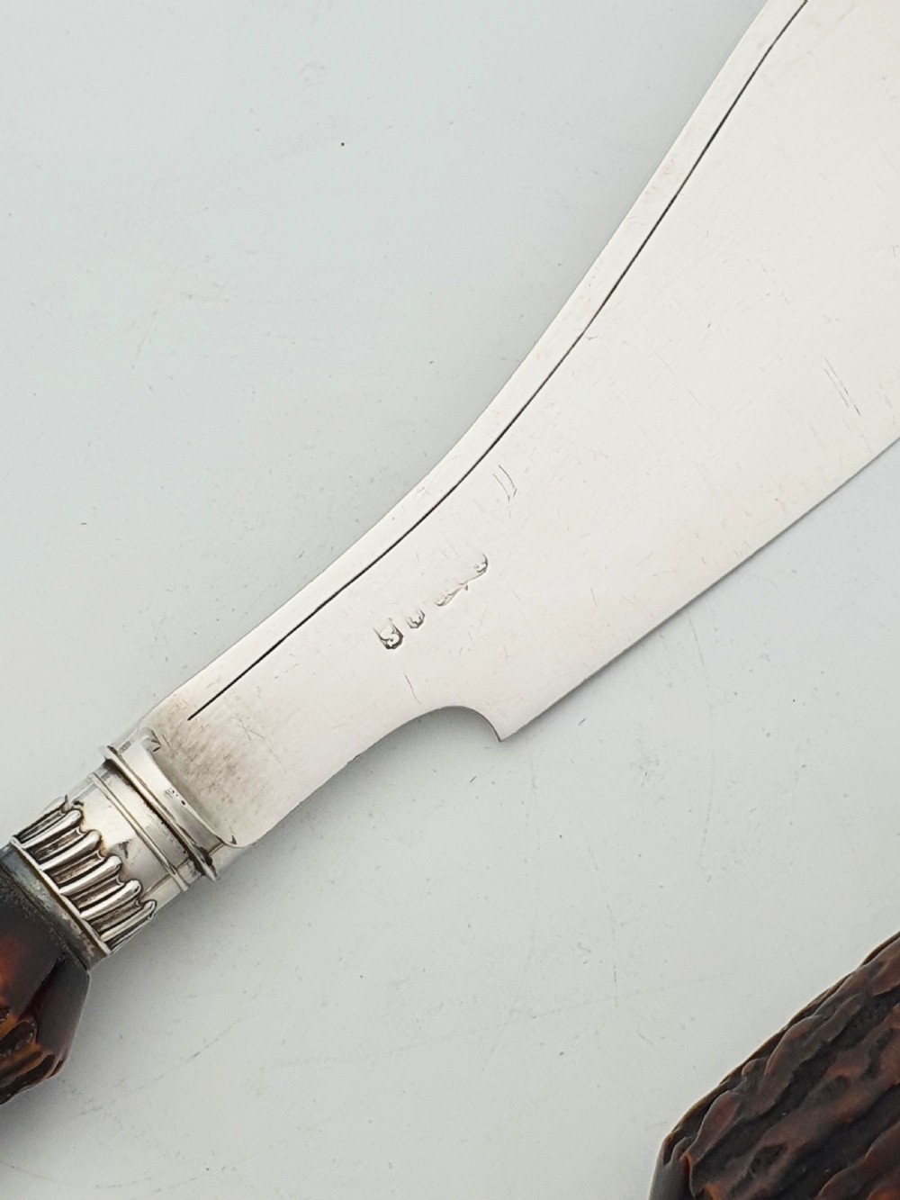 A pair of Victorian silver-plated fish servers with natural antler handles and engraved leaf patterns on the blade and fork. View VI