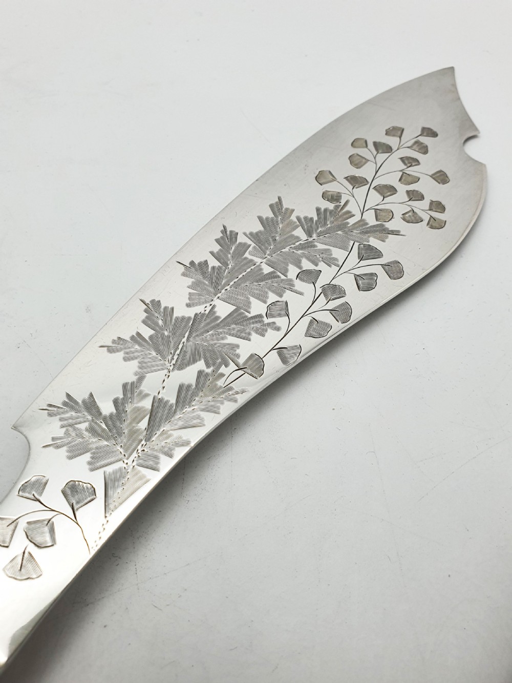 A pair of Victorian silver-plated fish servers with natural antler handles and engraved leaf patterns on the blade and fork. View VII