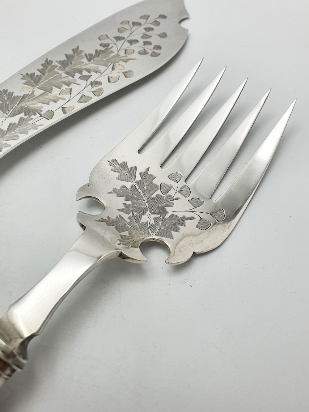 A pair of Victorian silver-plated fish servers with natural antler handles and engraved leaf patterns on the blade and fork. View VIII