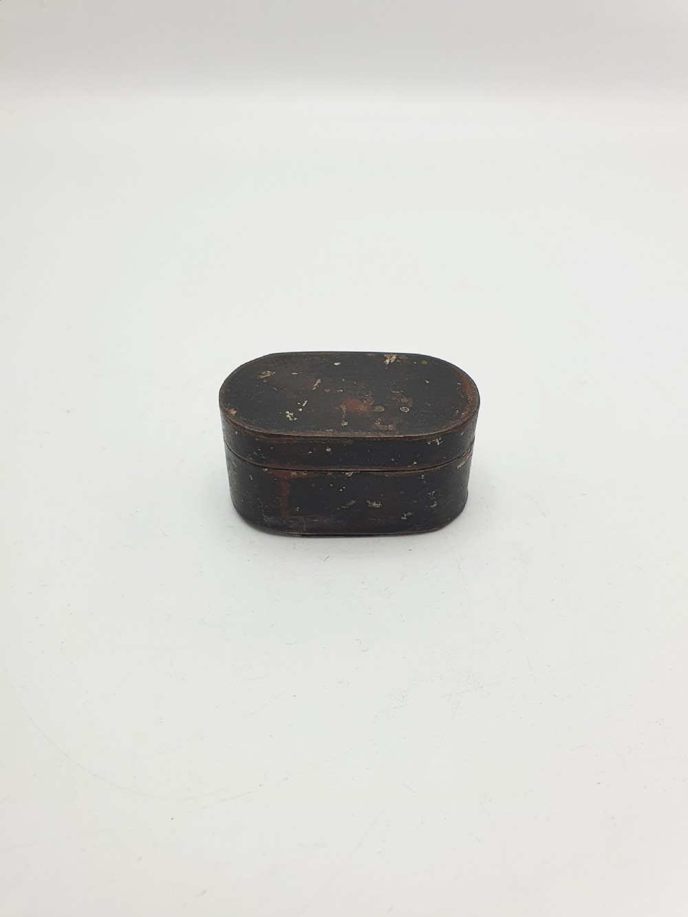 An open oval Georgian metal pocket nutmeg grater showing a hinged lid and a perforated grating surface with age patina. View IV