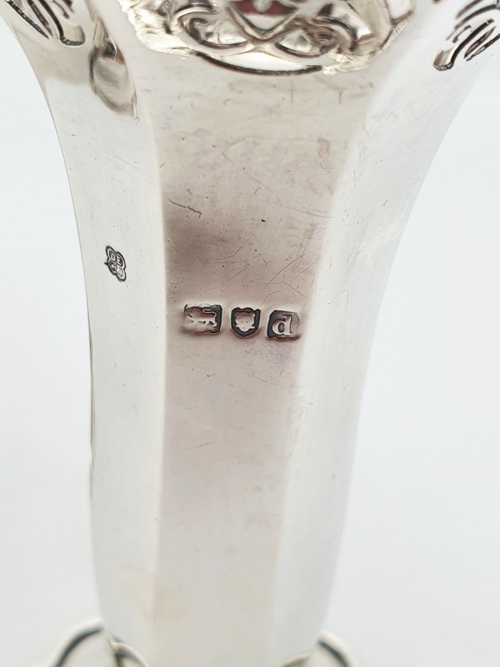 A pair of solid sterling silver trumpet vases featuring flared pierced rims with scroll details and octagonal stems. View VII