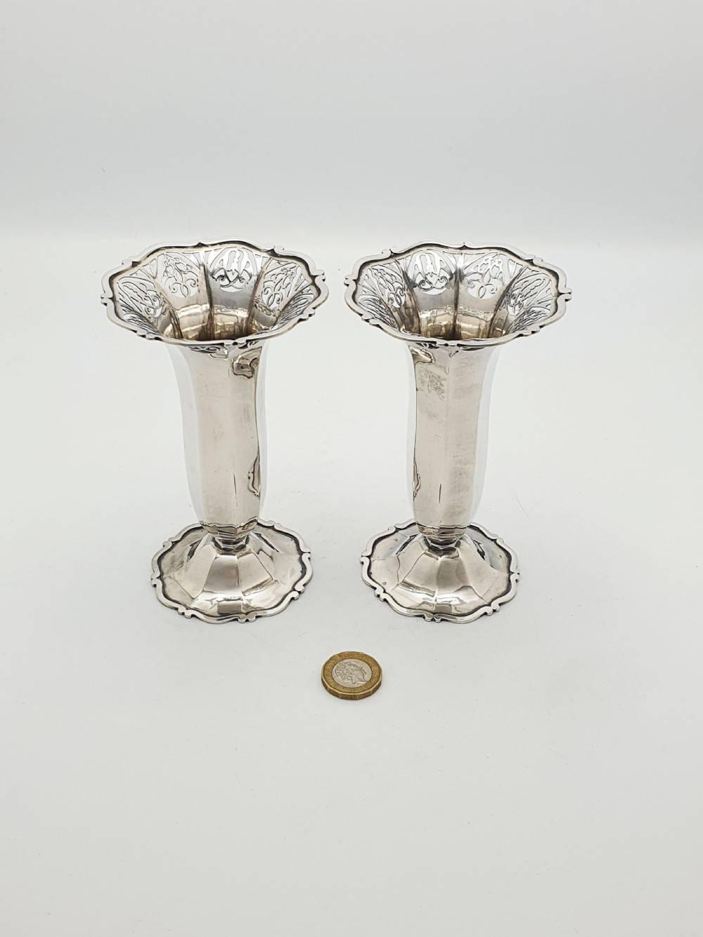 A pair of solid sterling silver trumpet vases featuring flared pierced rims with scroll details and octagonal stems. View VIII