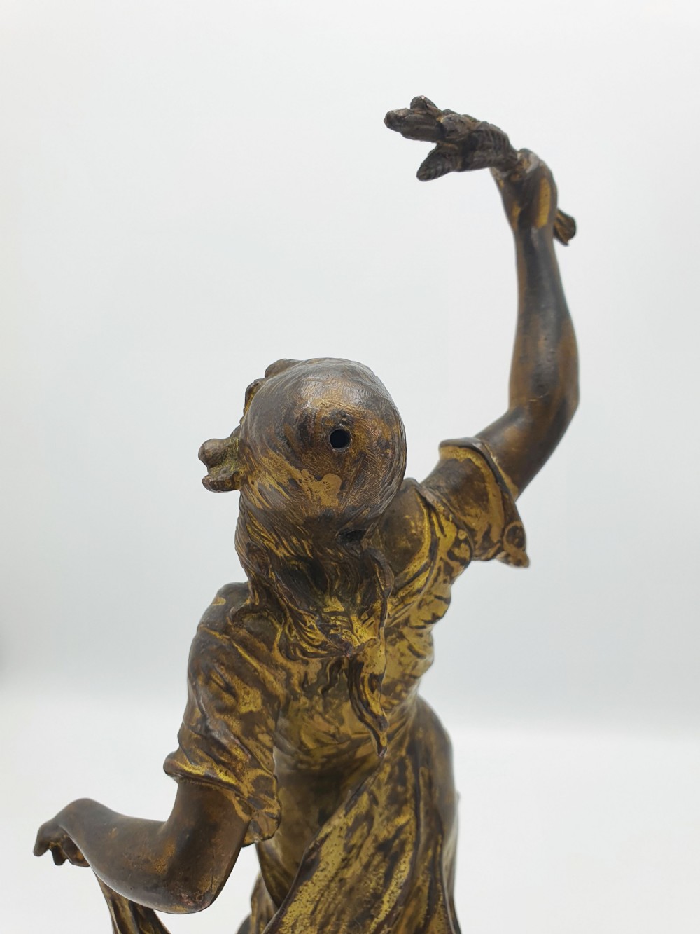 A pair of dark patinated bronze figurines depicting male and female harvest dancers holding floral garlands. View VII