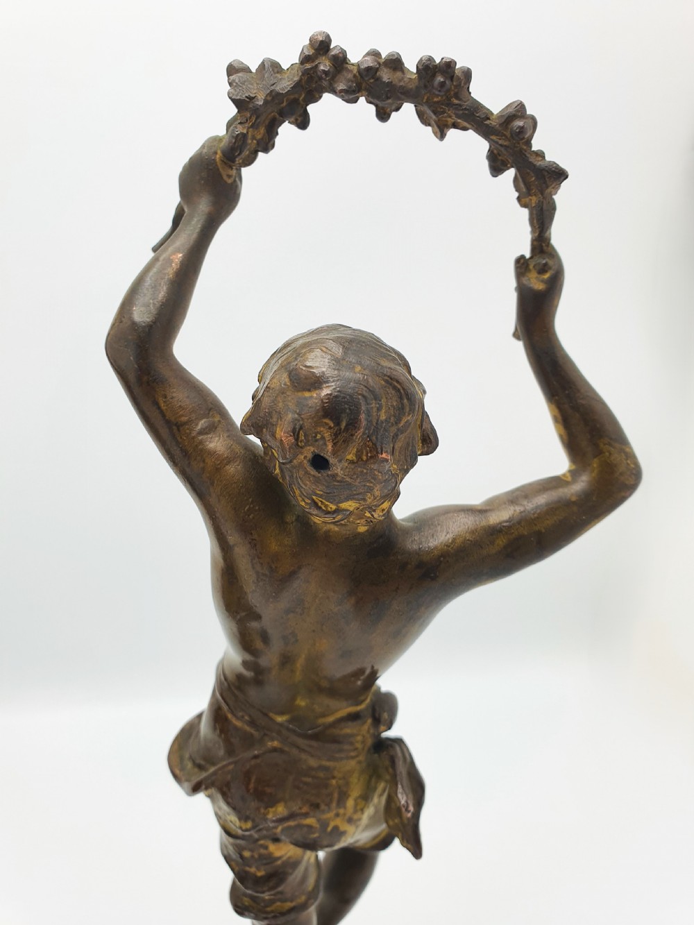 A pair of dark patinated bronze figurines depicting male and female harvest dancers holding floral garlands. View VIII