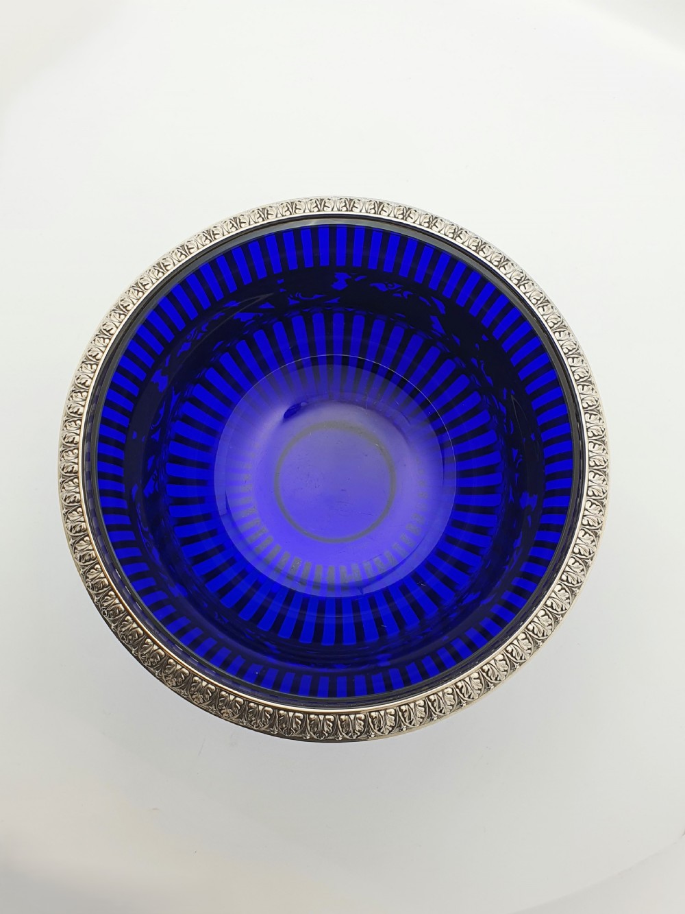 A German 800 silver centrepiece bowl featuring a pierced leaf and vine motif frame on a pedestal base with a cobalt blue glass liner. View V