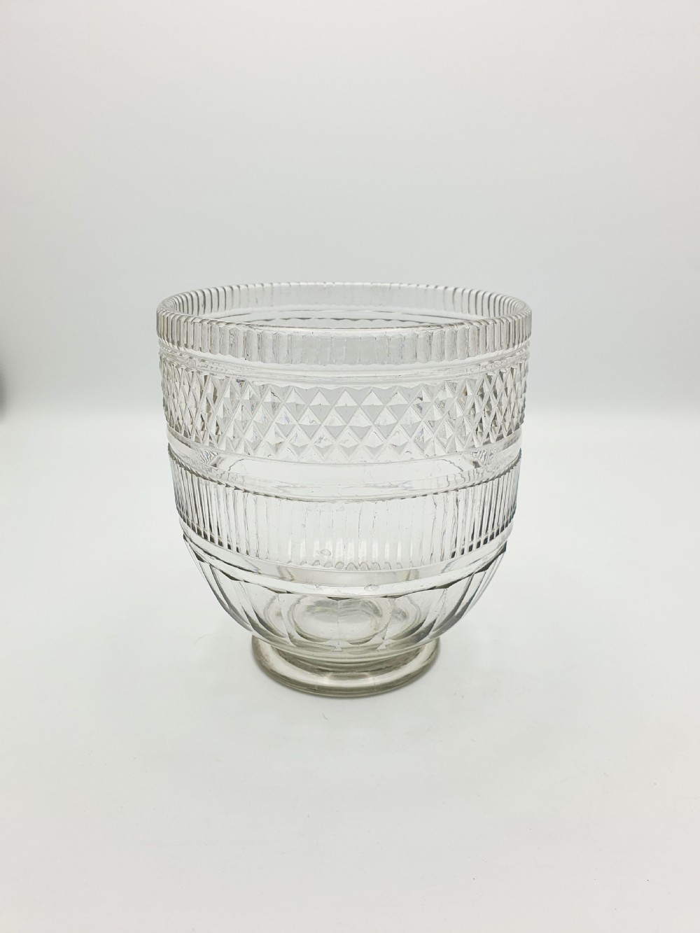A Georgian cut clear glass tea mixing bowl featuring diamond cut patterns, step-cut bands, and a footed base. View II