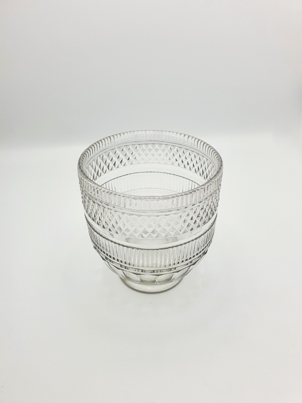A Georgian cut clear glass tea mixing bowl featuring diamond cut patterns, step-cut bands, and a footed base. View III