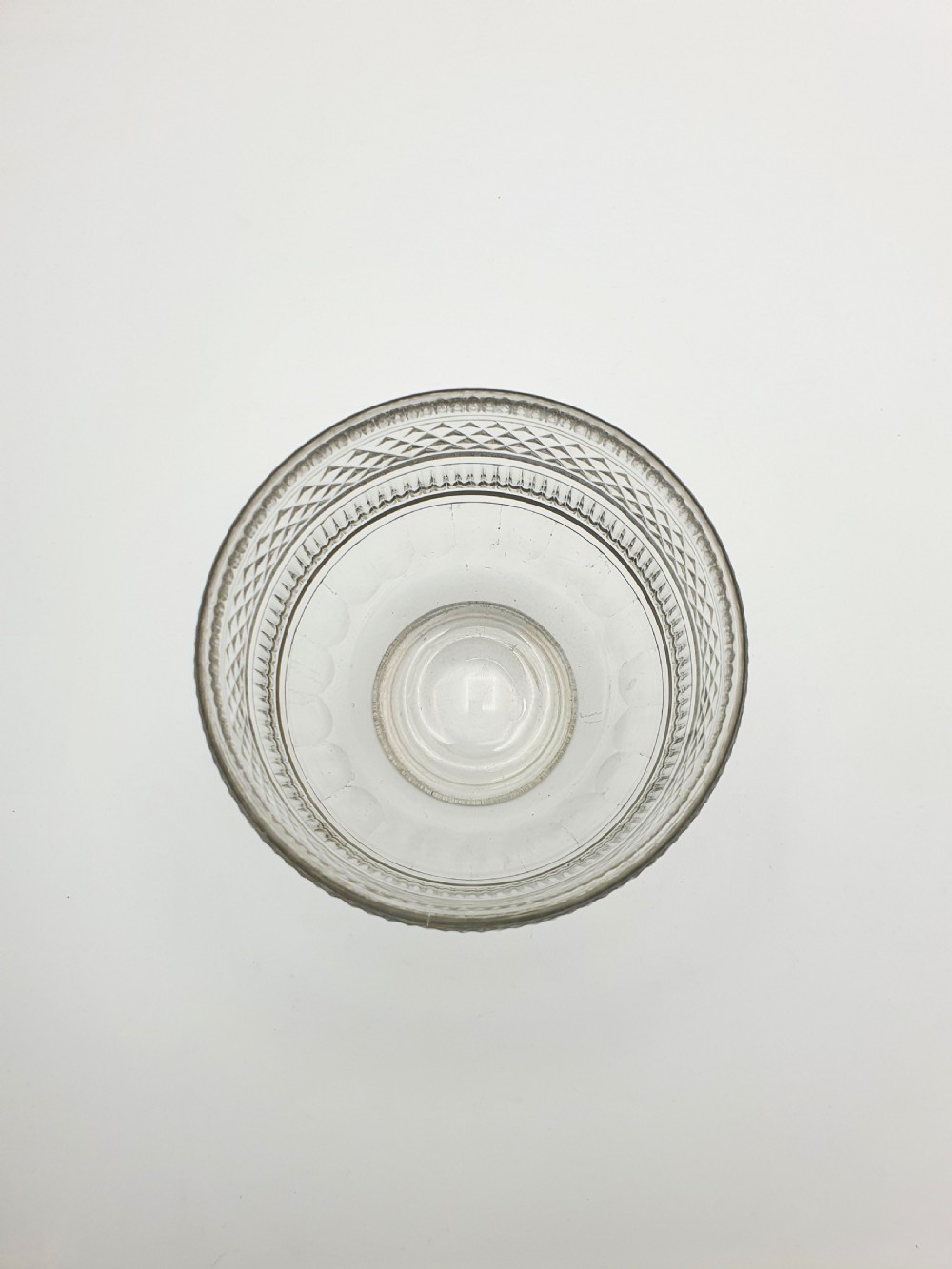 A Georgian cut clear glass tea mixing bowl featuring diamond cut patterns, step-cut bands, and a footed base. View V
