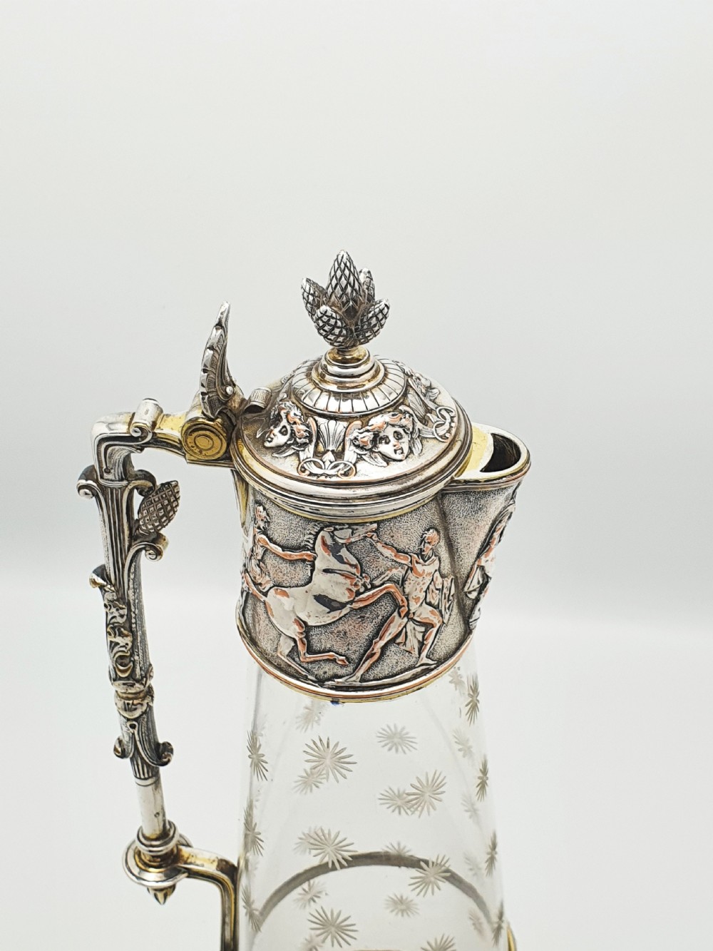 A tall Victorian silver-plated and etched glass claret jug featuring classical reliefs, a Greek key border, and star-cut engravings. View II