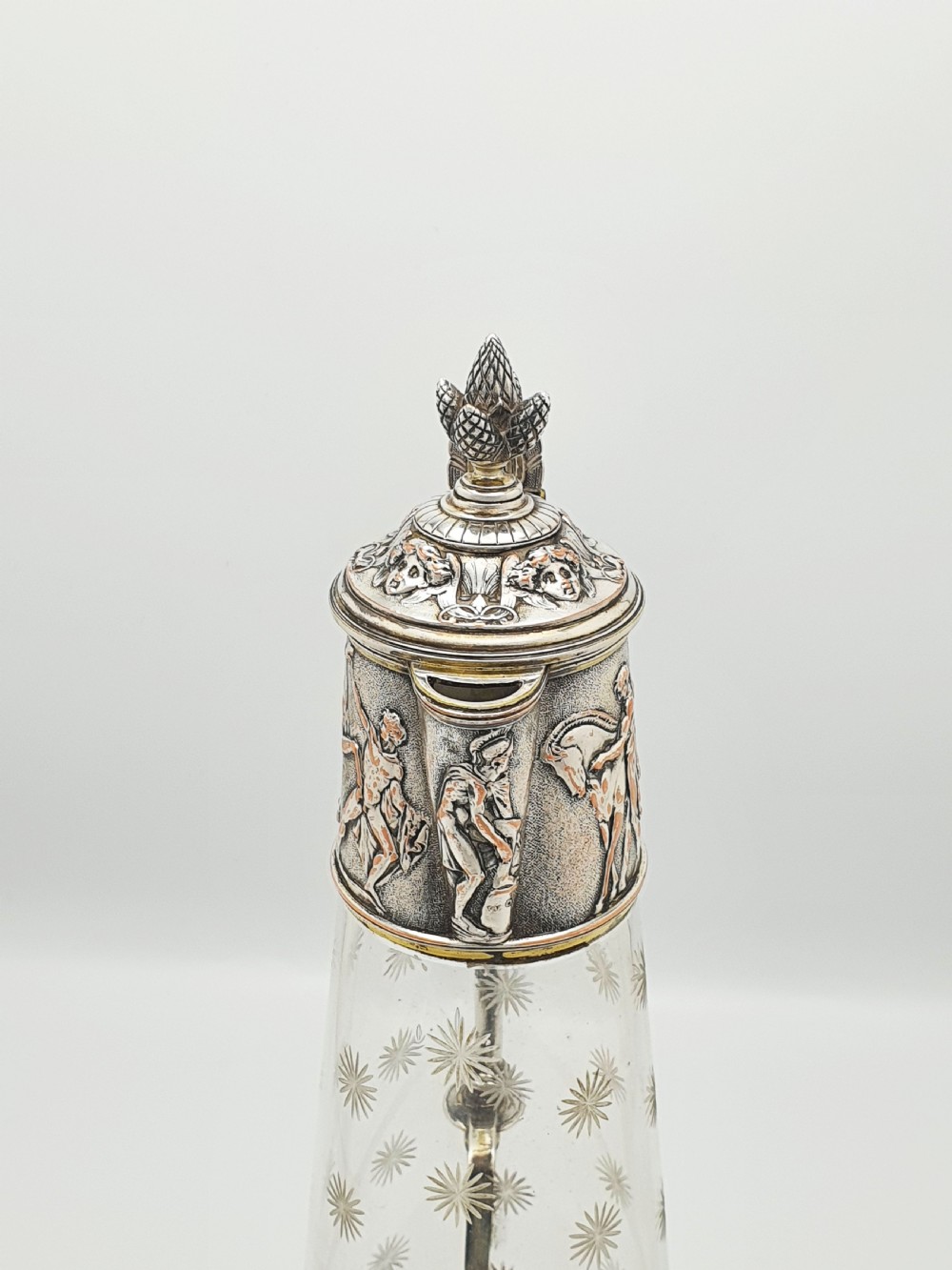 A tall Victorian silver-plated and etched glass claret jug featuring classical reliefs, a Greek key border, and star-cut engravings. View V