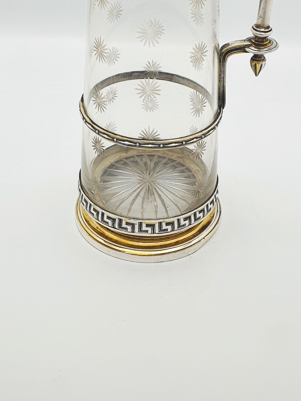 A tall Victorian silver-plated and etched glass claret jug featuring classical reliefs, a Greek key border, and star-cut engravings. View VII