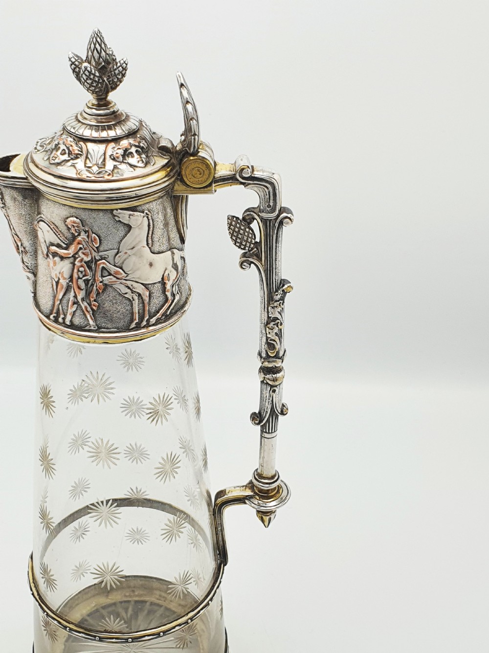 A tall Victorian silver-plated and etched glass claret jug featuring classical reliefs, a Greek key border, and star-cut engravings. View VIII
