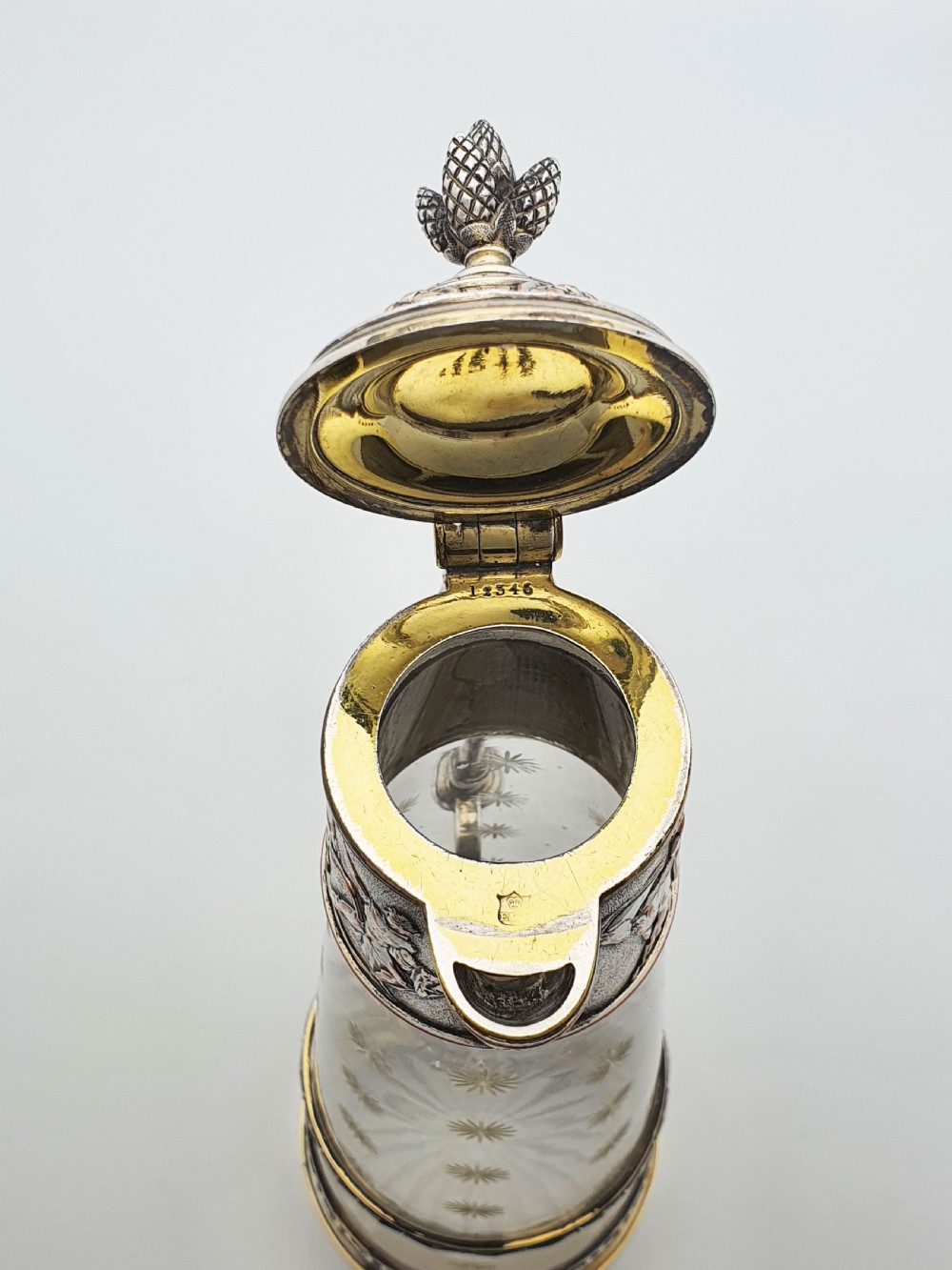 A tall Victorian silver-plated and etched glass claret jug featuring classical reliefs, a Greek key border, and star-cut engravings. View X