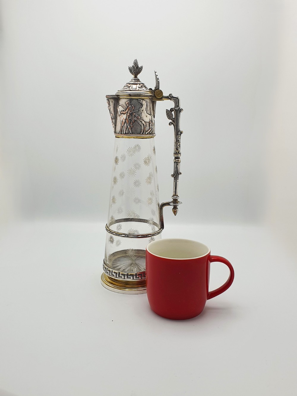 A tall Victorian silver-plated and etched glass claret jug featuring classical reliefs, a Greek key border, and star-cut engravings. View XIV