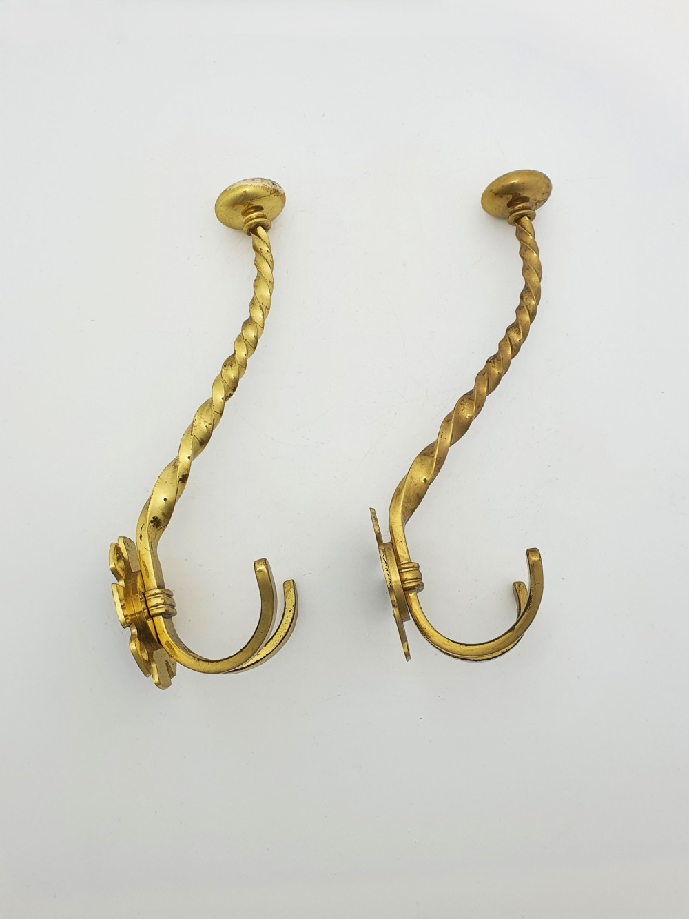 A pair of antique Victorian brass coat hooks with barley twist stems and multi-prong bases. View III