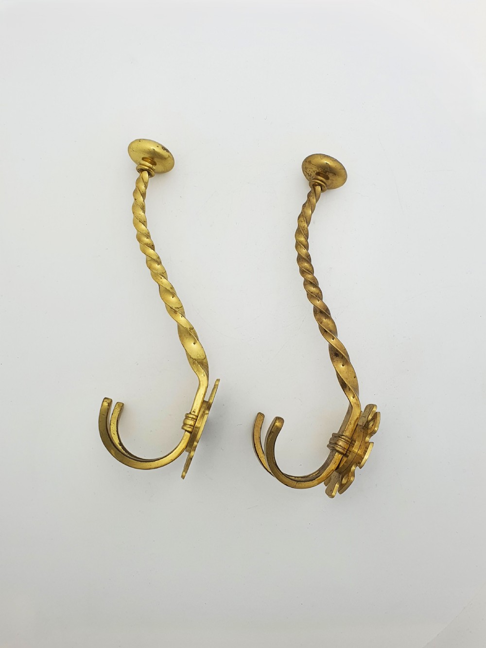A pair of antique Victorian brass coat hooks with barley twist stems and multi-prong bases. View IV