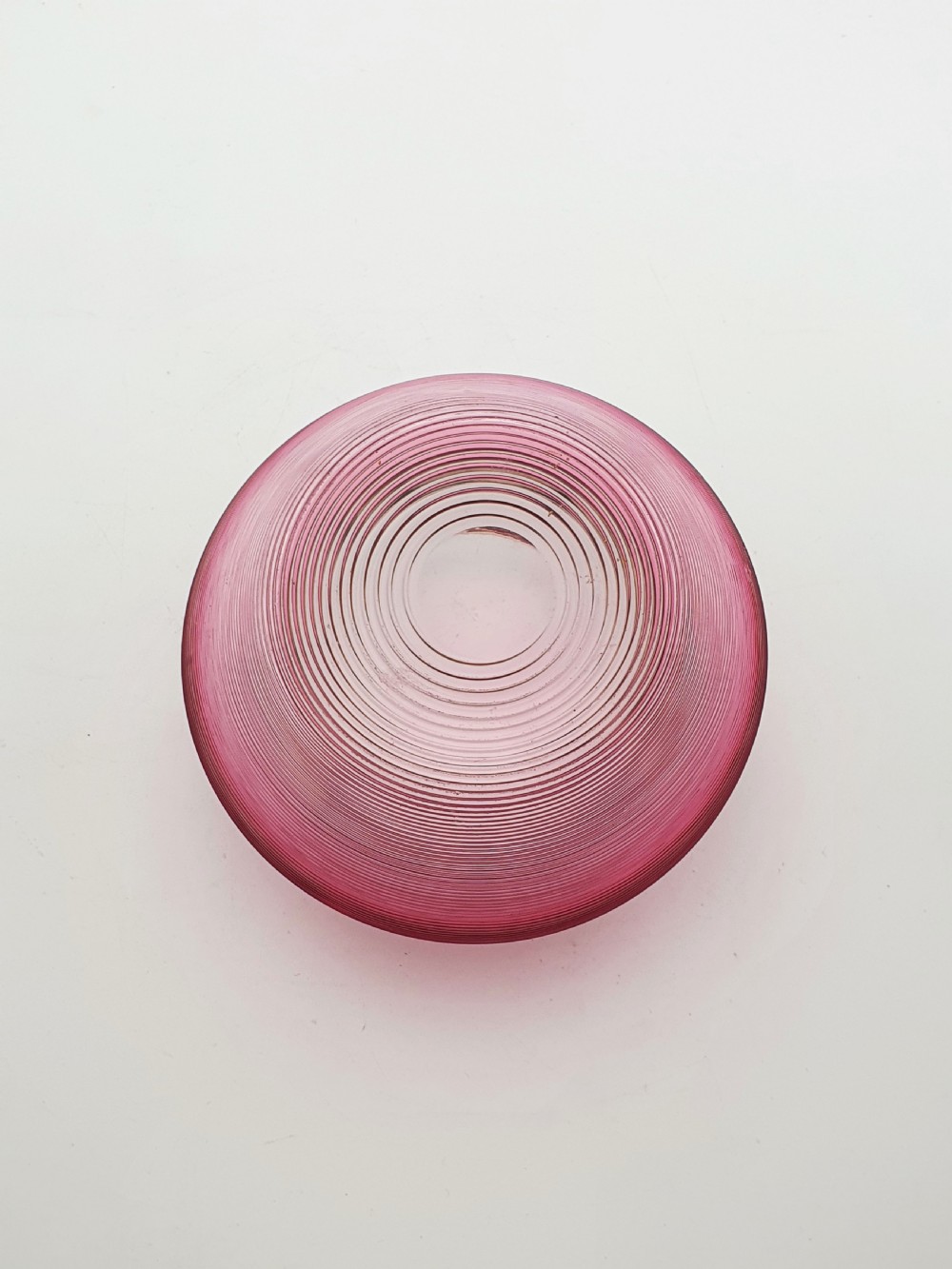 A ribbed cranberry glass biscuit barrel featuring a silver-plated fitted rim, flat lid, and hinged swing handle. View VIII