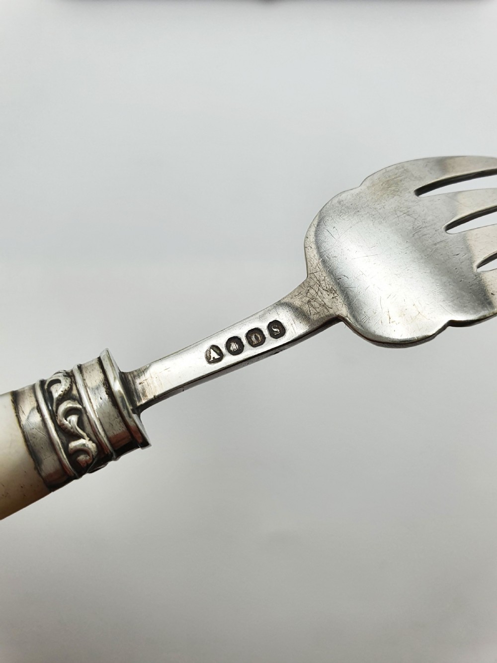 A cased set of six Victorian hors doeuvres forks featuring mother-of-pearl handles and engraved silver-plated tines, presented in a blue fabric-lined box. View VI