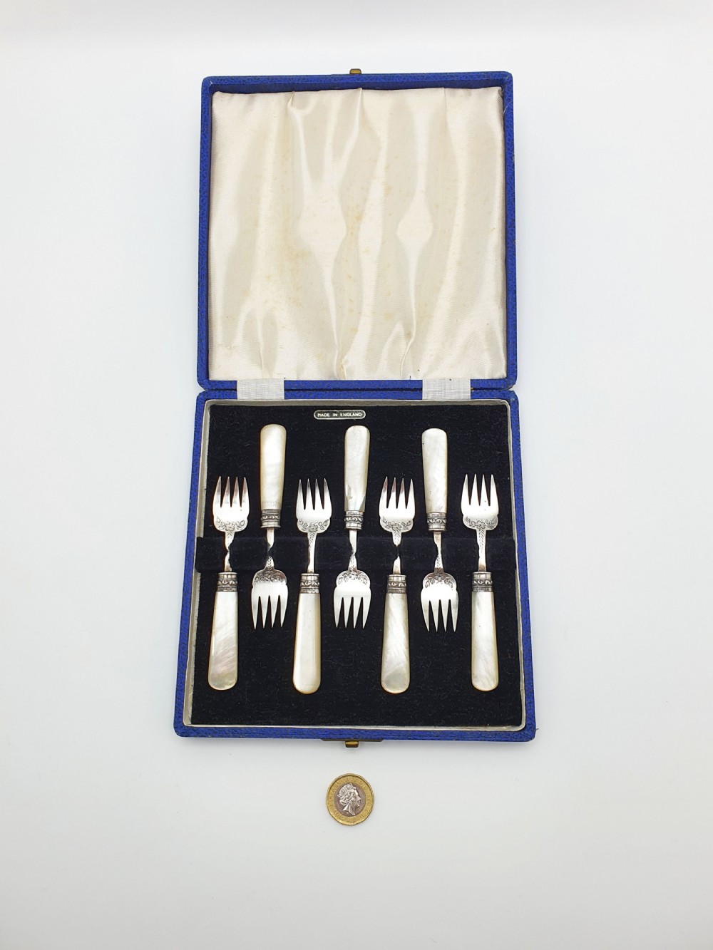 A cased set of six Victorian hors doeuvres forks featuring mother-of-pearl handles and engraved silver-plated tines, presented in a blue fabric-lined box. View VII