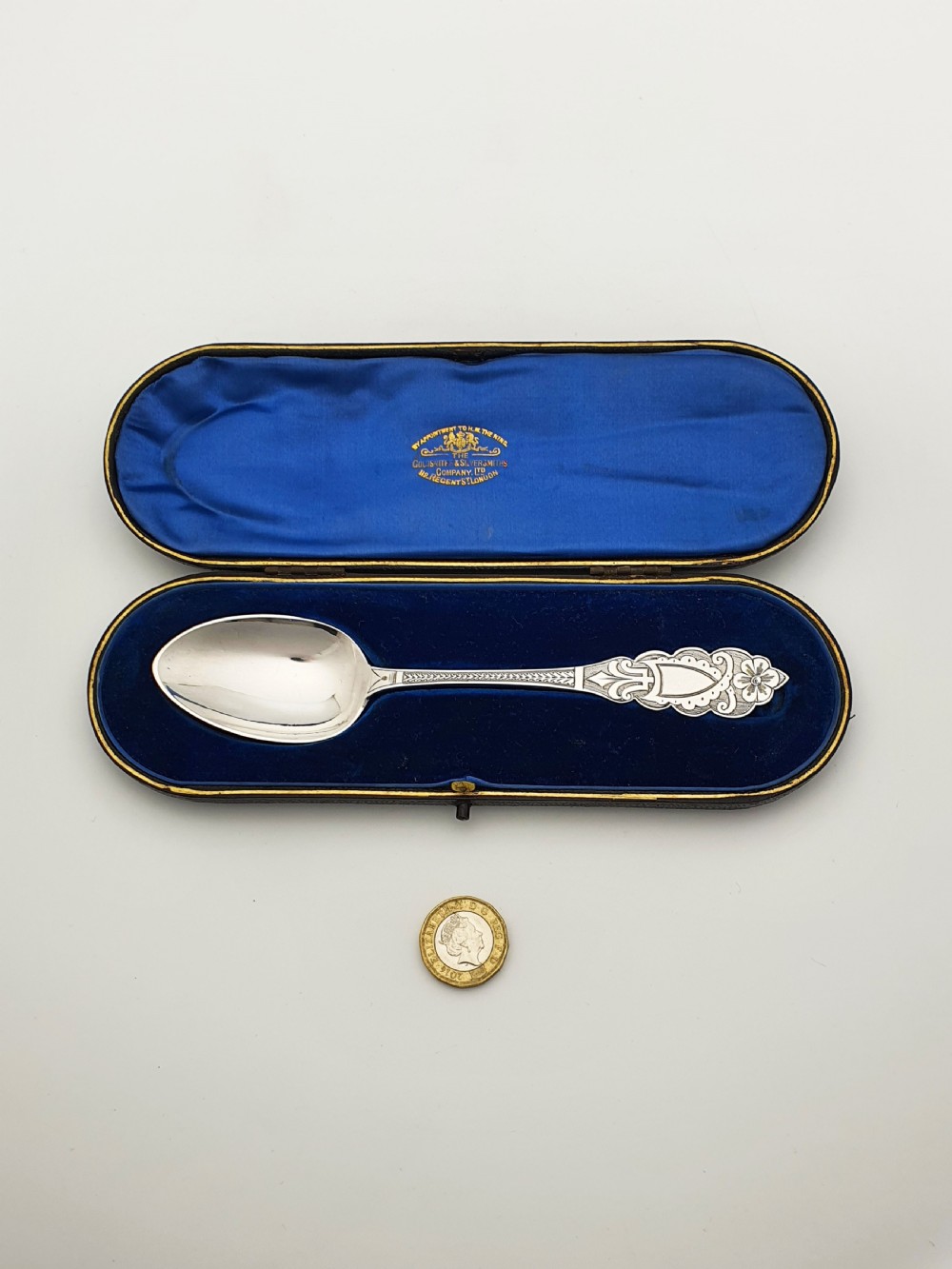 An 1877 Victorian sterling silver presentation spoon with an engraved stag motif inside an open blue velvet presentation box. View VIII