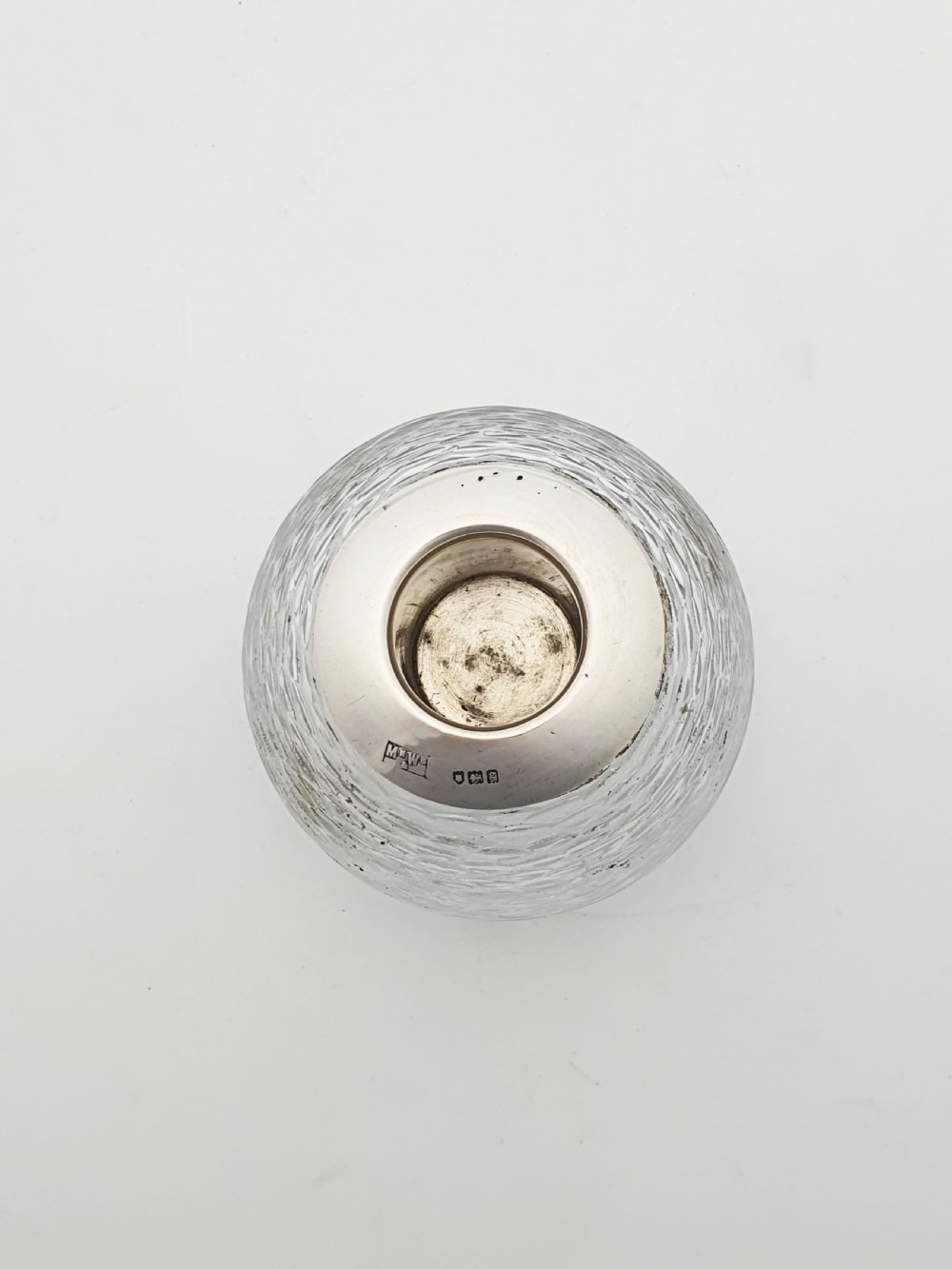 An Edwardian spherical glass match striker featuring a textured rib outer surface and a hallmarked sterling silver collar at the top aperture. View III