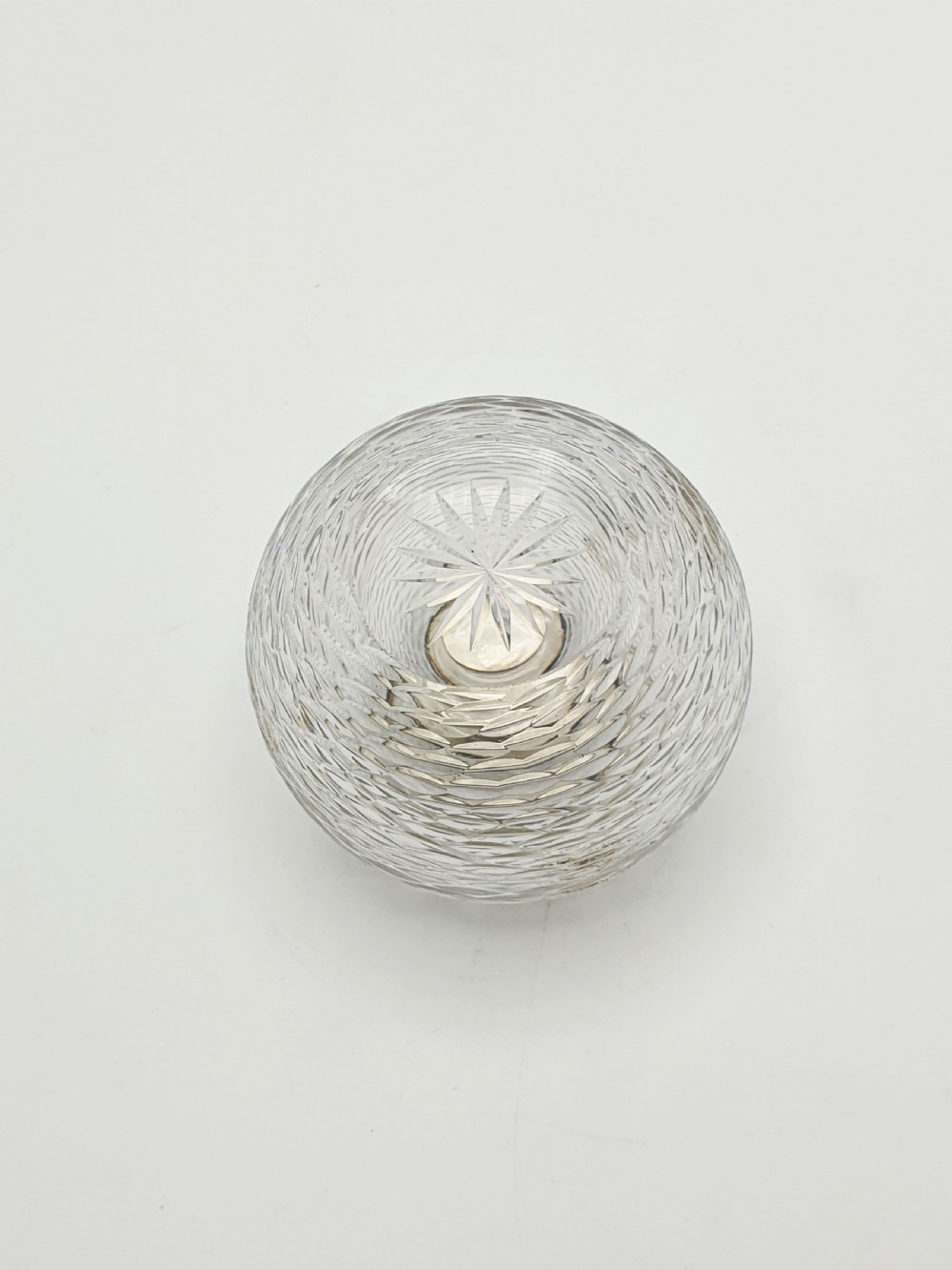 An Edwardian spherical glass match striker featuring a textured rib outer surface and a hallmarked sterling silver collar at the top aperture. View V