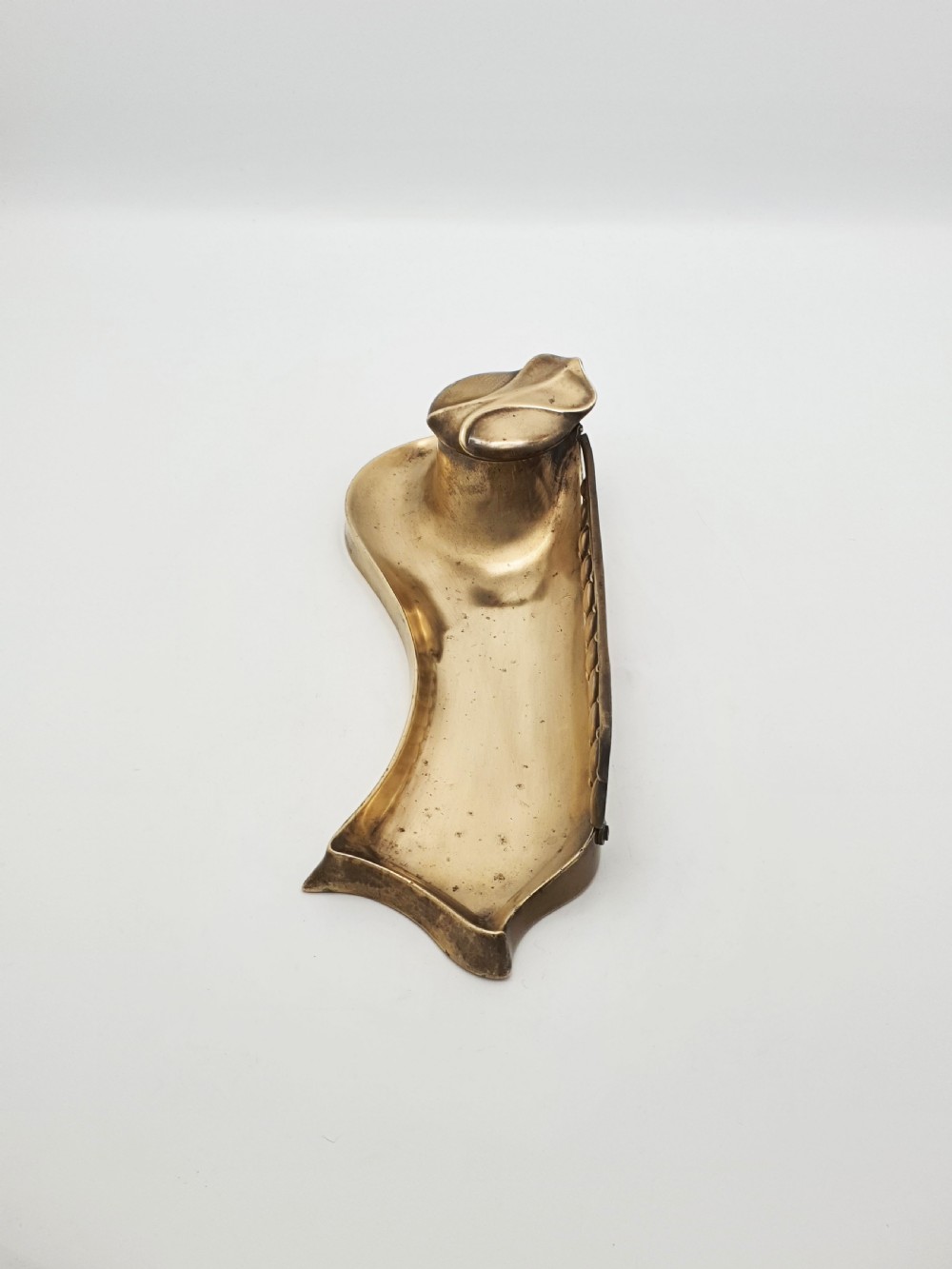 An Art Nouveau cast bronze inkwell featuring a hinged lid, organic curved pen rest tray, and decorative beaded back gallery. View VI